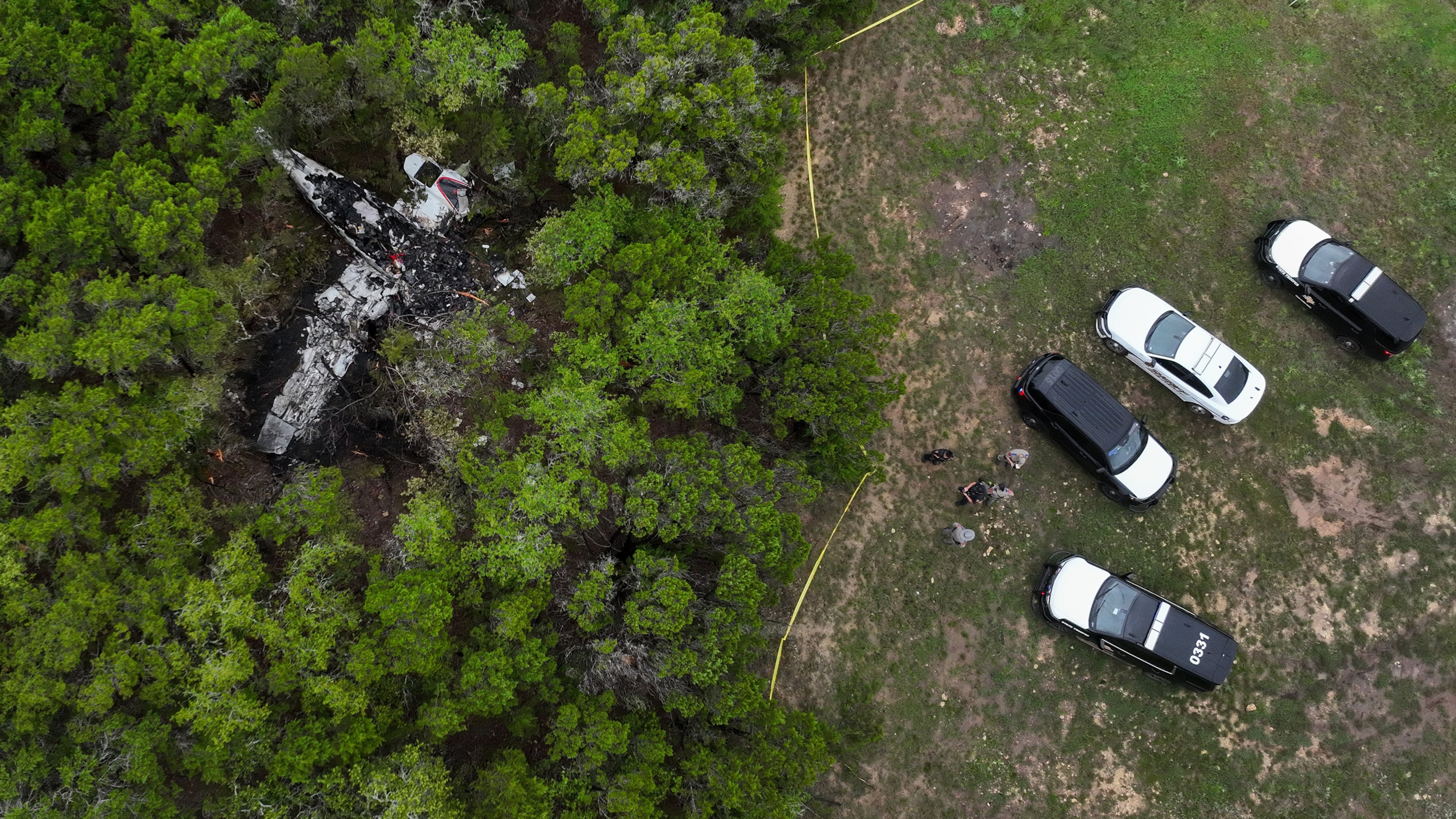A crashed Cessna airplane is seen in a wooded area on Round Rock Road in Wimberley, Texas, Friday, May 1, 2026. (Jay Janner/Austin American-Statesman via AP)