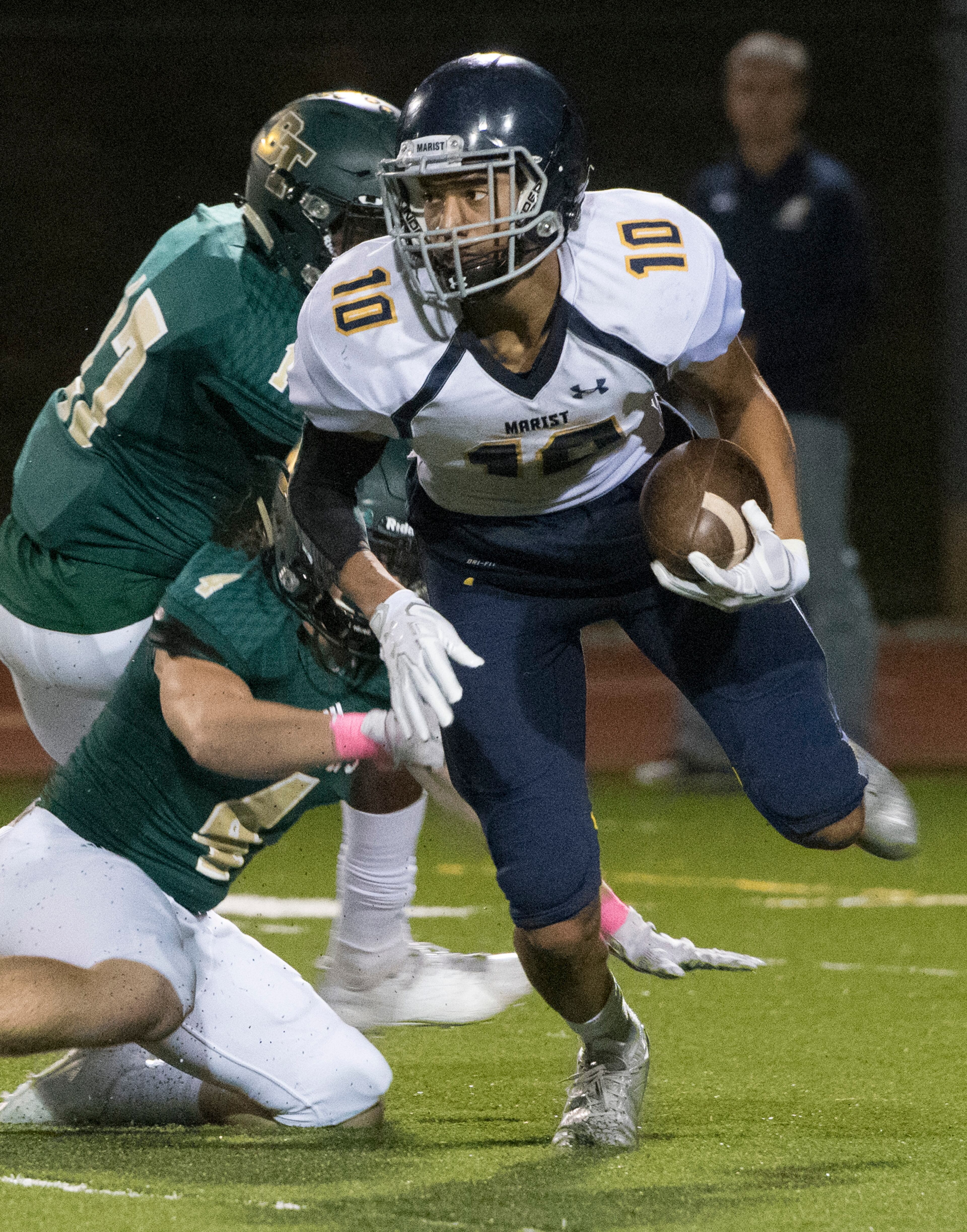 Marist WR Kyle Hamilton (10) tries to get away from Blessed Trinity LB Alex Poma (4) during a high school football game, Friday, Oct. 20, 2017, in Roswell. (John Amis)