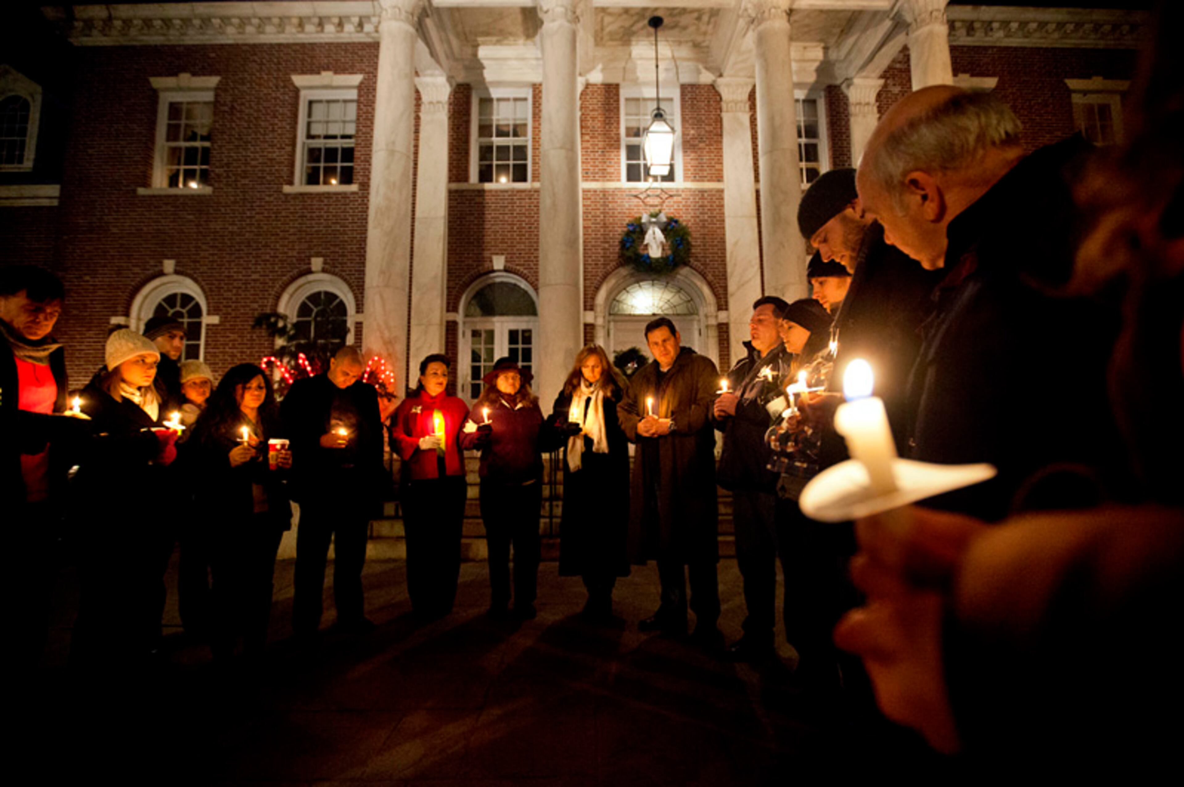 Mourners gather for a candlelight vigil outside the Edmond Town Hall, Saturday, Dec. 15, 2012, in Newtown, Conn.