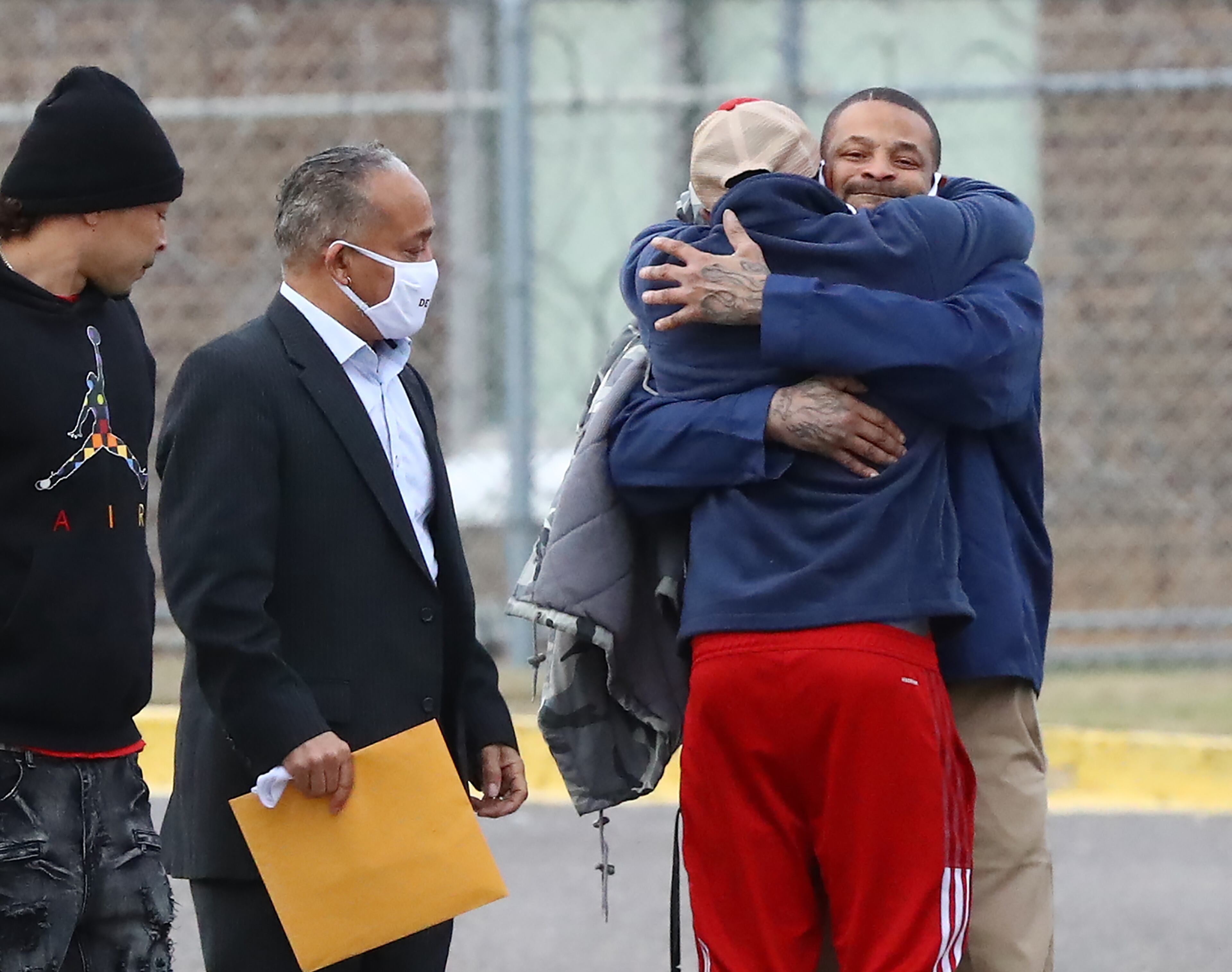 122021 Grovetown: Devonia Inman hugs his son Travenski Jaskson (center) outside Augusta State Medical Prison being released from custody after serving 23 years in prison for a wrongful conviction on Monday, Dec 20, 2021, in Grovetown. His charges were dismissed in a murder case. “Curtis Compton / Curtis.Compton@ajc.com”`