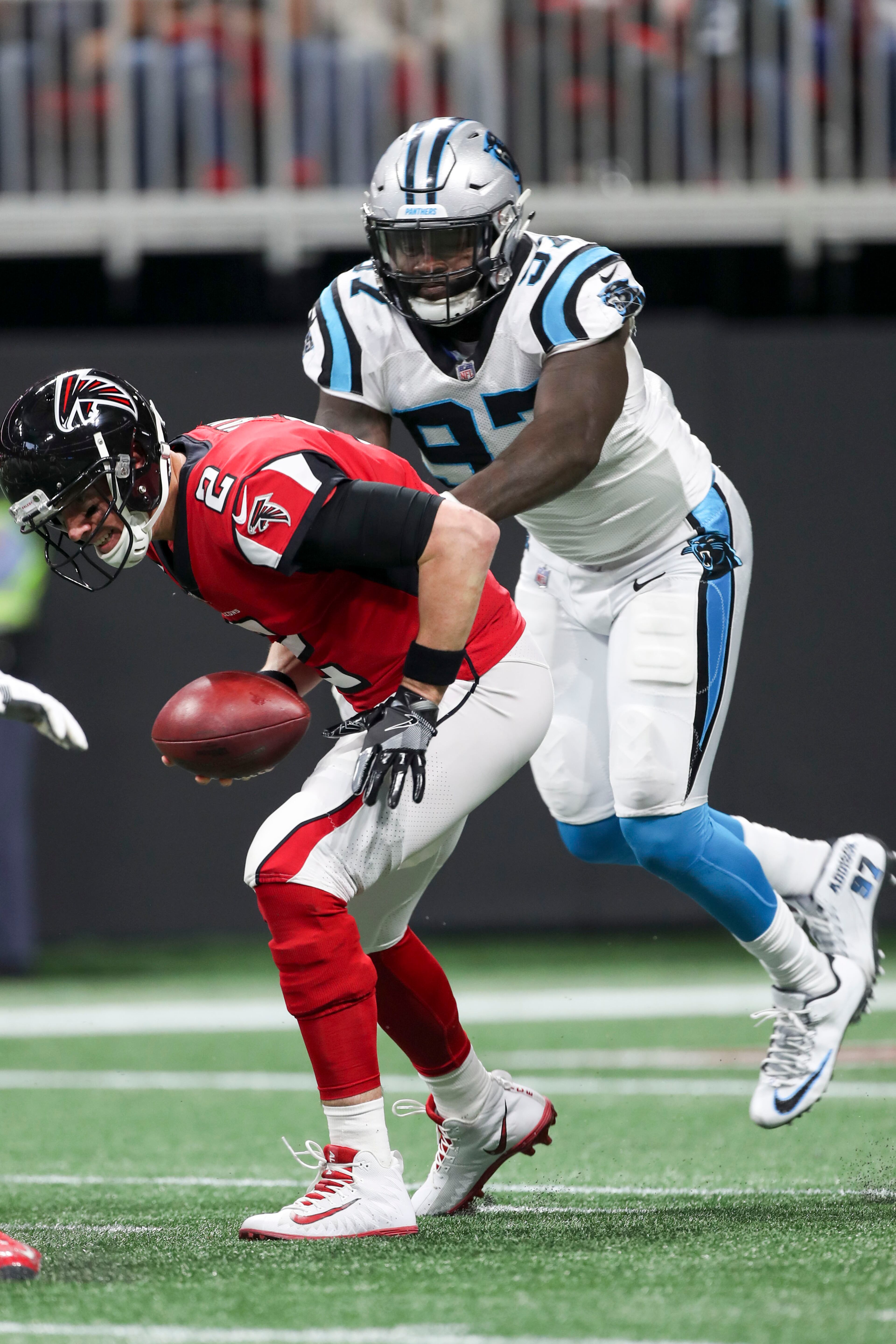 12/31/2017 -- Atlanta, GA, - Atlanta Falcons quarterback Matt Ryan (2) scrambles out of a sack from Carolina Panthers defensive end Mario Addison (97) during the first quarter of the game at Mercedes Benz Stadium, Sunday, December 31, 2017. ALYSSA POINTER/ALYSSA.POINTER@AJC.COM
