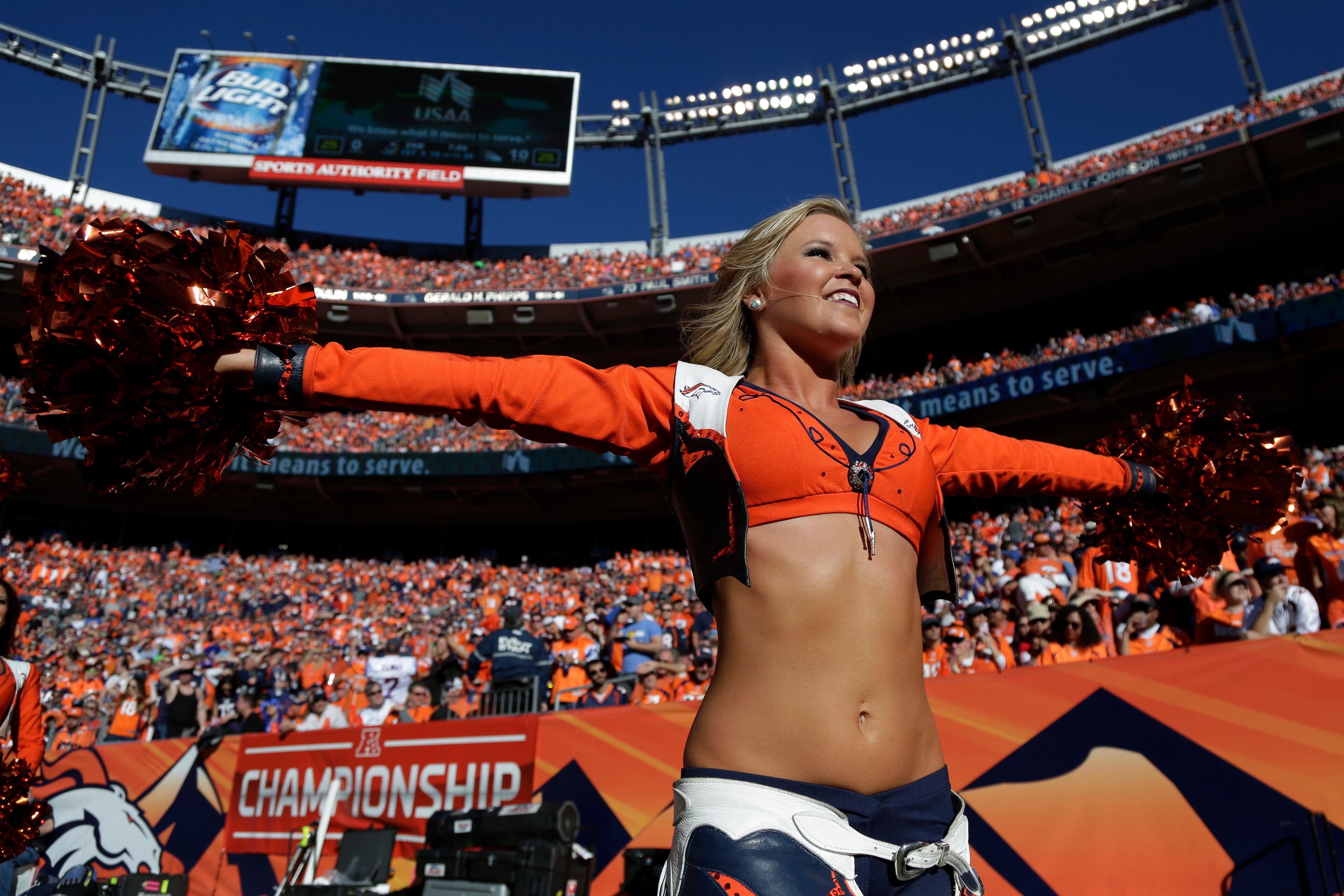 A Denver Broncos cheerleader performs during the first half of the AFC Championship NFL playoff football game between the Denver Broncos and the New England Patriots in Denver on Jan. 19, 2014.