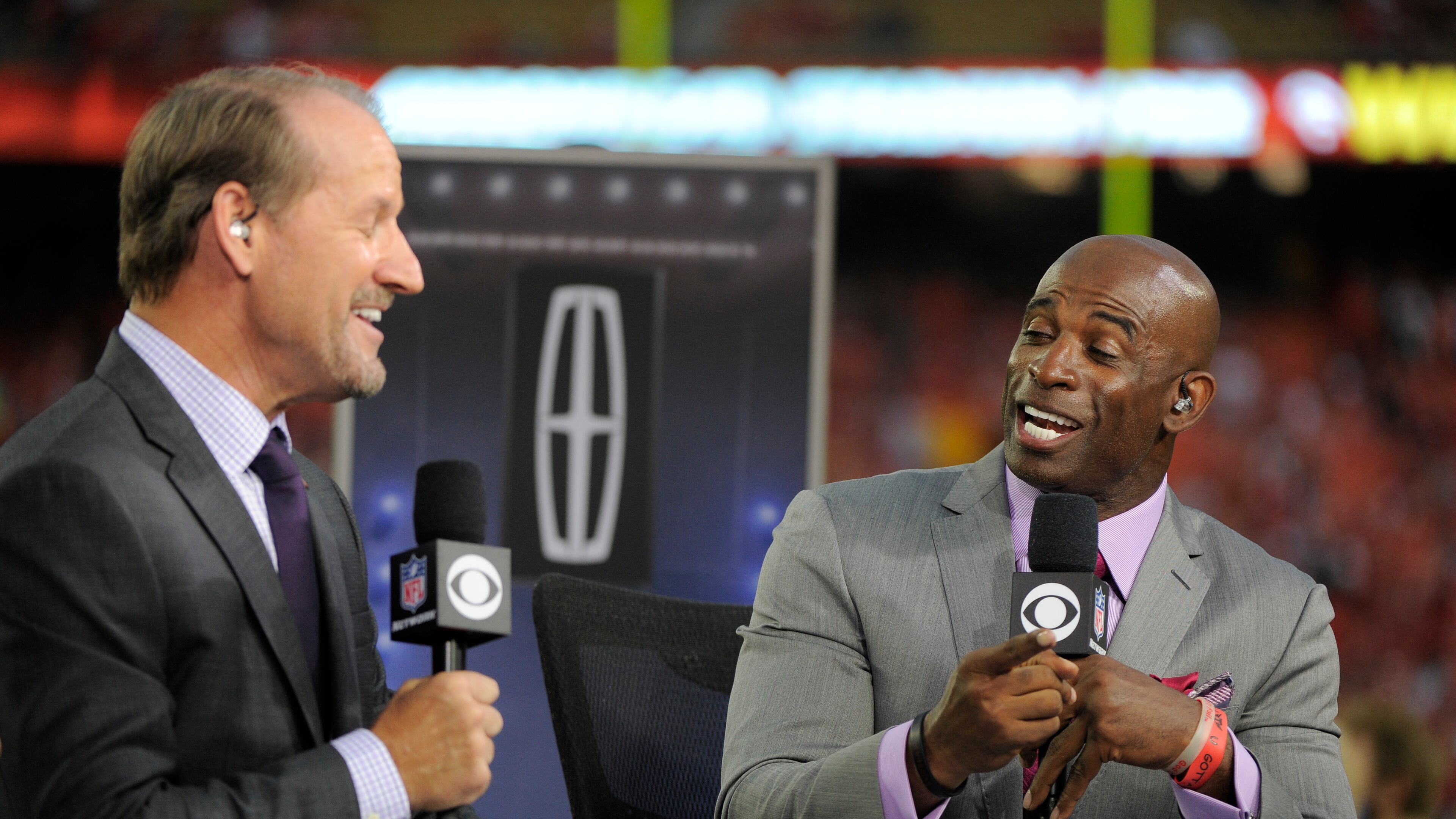 Bill Cowher and Deion Sanders, right, appear on the CBS Thursday Night Football television program at Arrowhead Stadium before an NFL football game between the Kansas City Chiefs and the Denver Broncos, in Kansas City, Mo., Thursday, Sept. 17, 2015. (AP Photo/Ed Zurga)