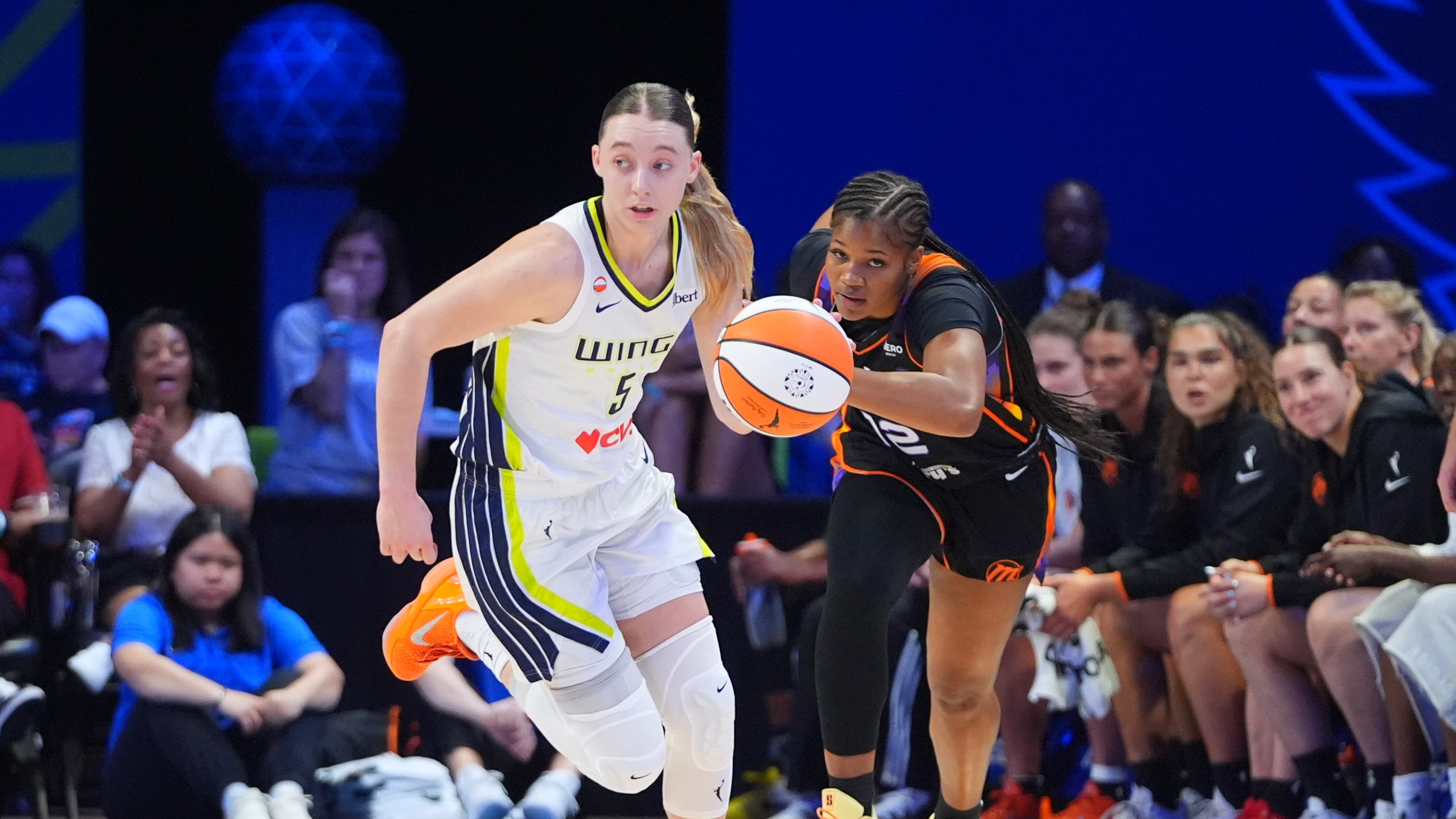 Dallas Wings guard Paige Bueckers (5) comes up with ball against Phoenix Mercury guard Kara Dunn (12) during the first half of a WNBA basketball game in Arlington, Texas, Saturday, Sept. 19, 2026. (AP Photo/LM Otero)