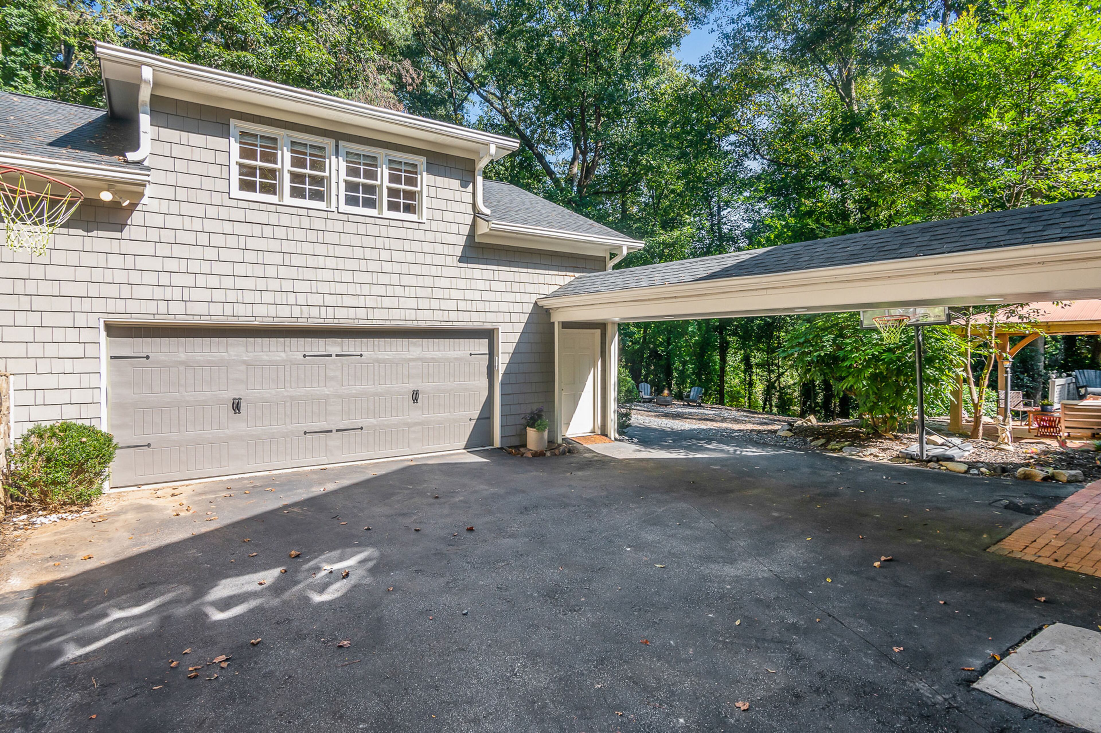 Separate oversized two-car garage and one car carport in the rear. Text by Stephanie Lewis Wilson