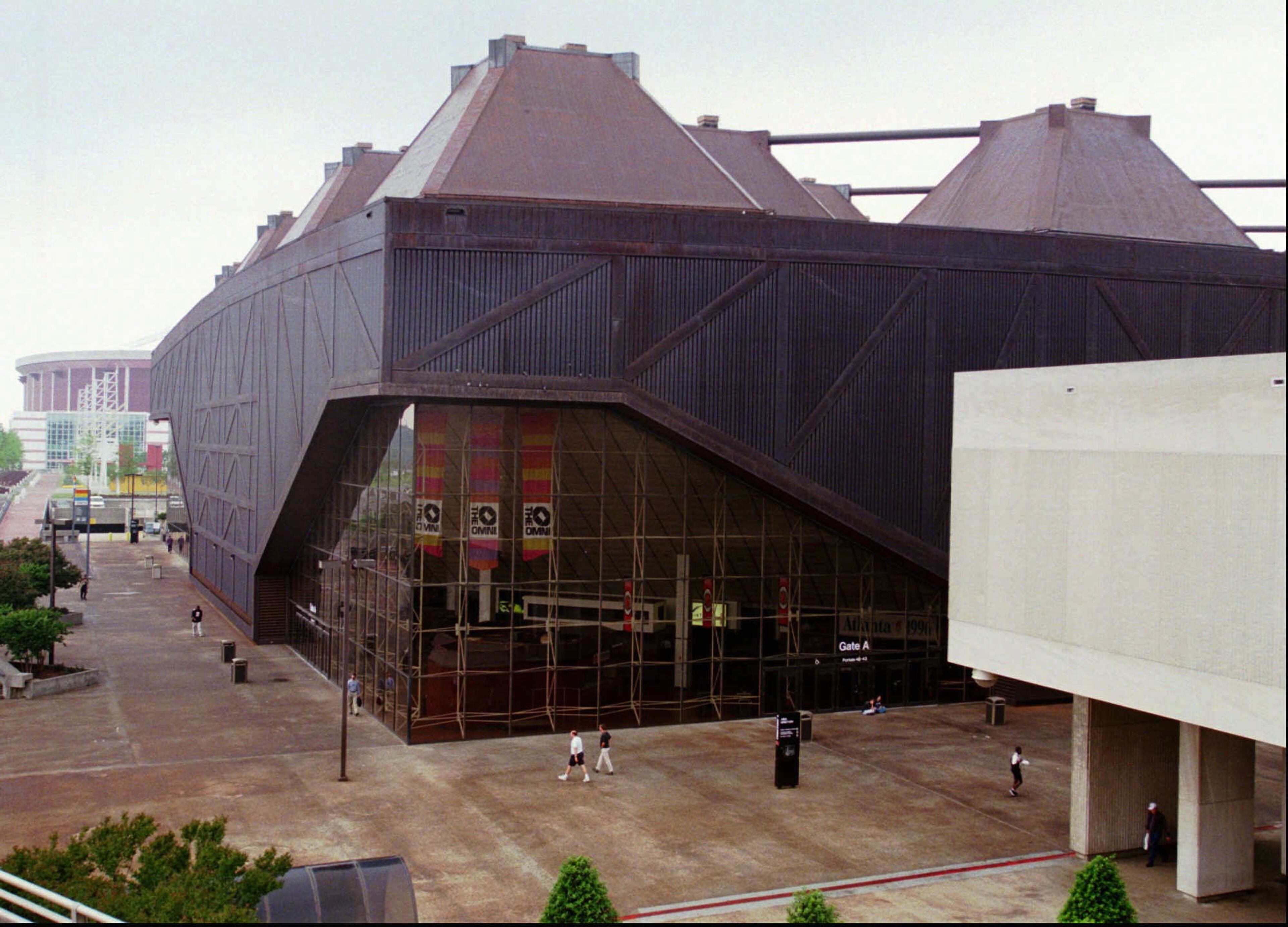 FILE--Pedestrians walk on the concourse surrounding The Omni in downtown Atlanta Tuesday, April 22, 1997. Atlanta, which lost the Flames to Calgary in 1980, moved to the front of the NHL expansion race Wednesday June 4, 1997 when a deal for a $213 million arena cleared its final governmental hurdle. Turner Broadcasting System executives were jubilant after the Fulton County Commission approved plans calling for the new arena to be built on the site of the Omni.(AP Photo/Ric Feld)