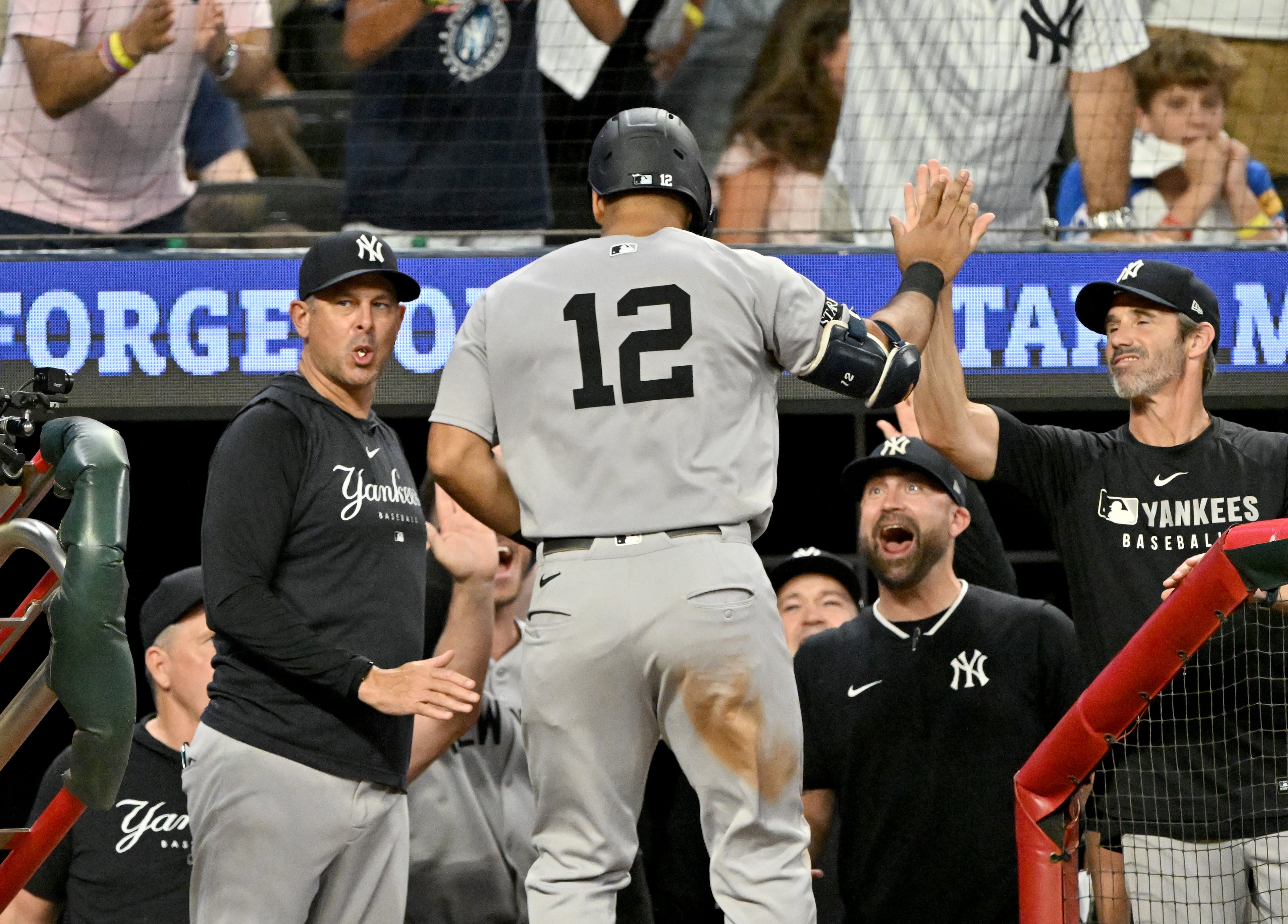 New York Yankees outfielder Trent Grisham (12) celebrates with teammates after hitting a grand slam during the ninth inning of a baseball game at Truist Park, Saturday, July 19, 2025, in Atlanta. New York Yankees won 12-9 over Atlanta Braves. (Hyosub Shin / AJC)