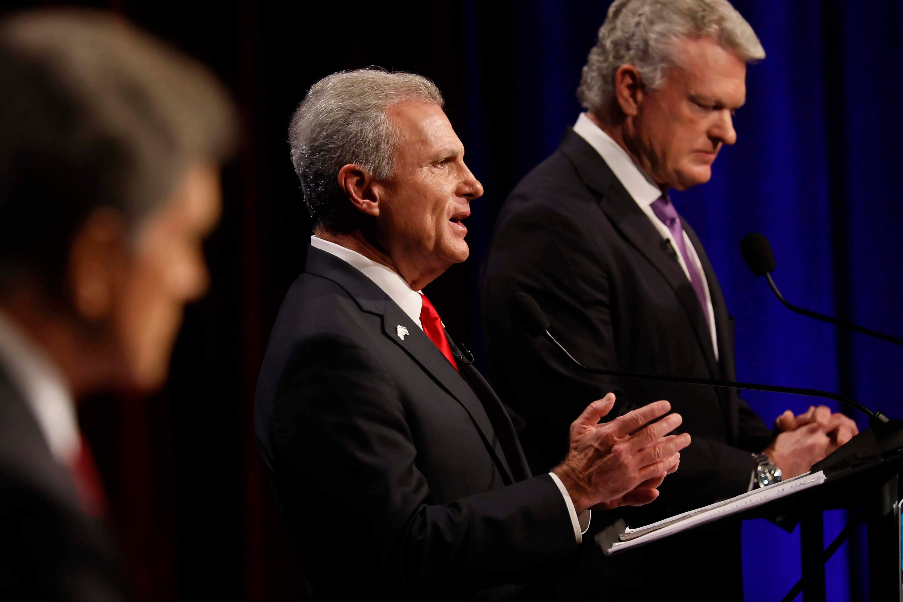 U.S. Rep. Buddy Carter, R-St. Simons Island, center, responds to a question from a panelist during the Atlanta Press Club Loudermilk-Young debate for the U.S. Senate last month. (Miguel Martinez/AJC)