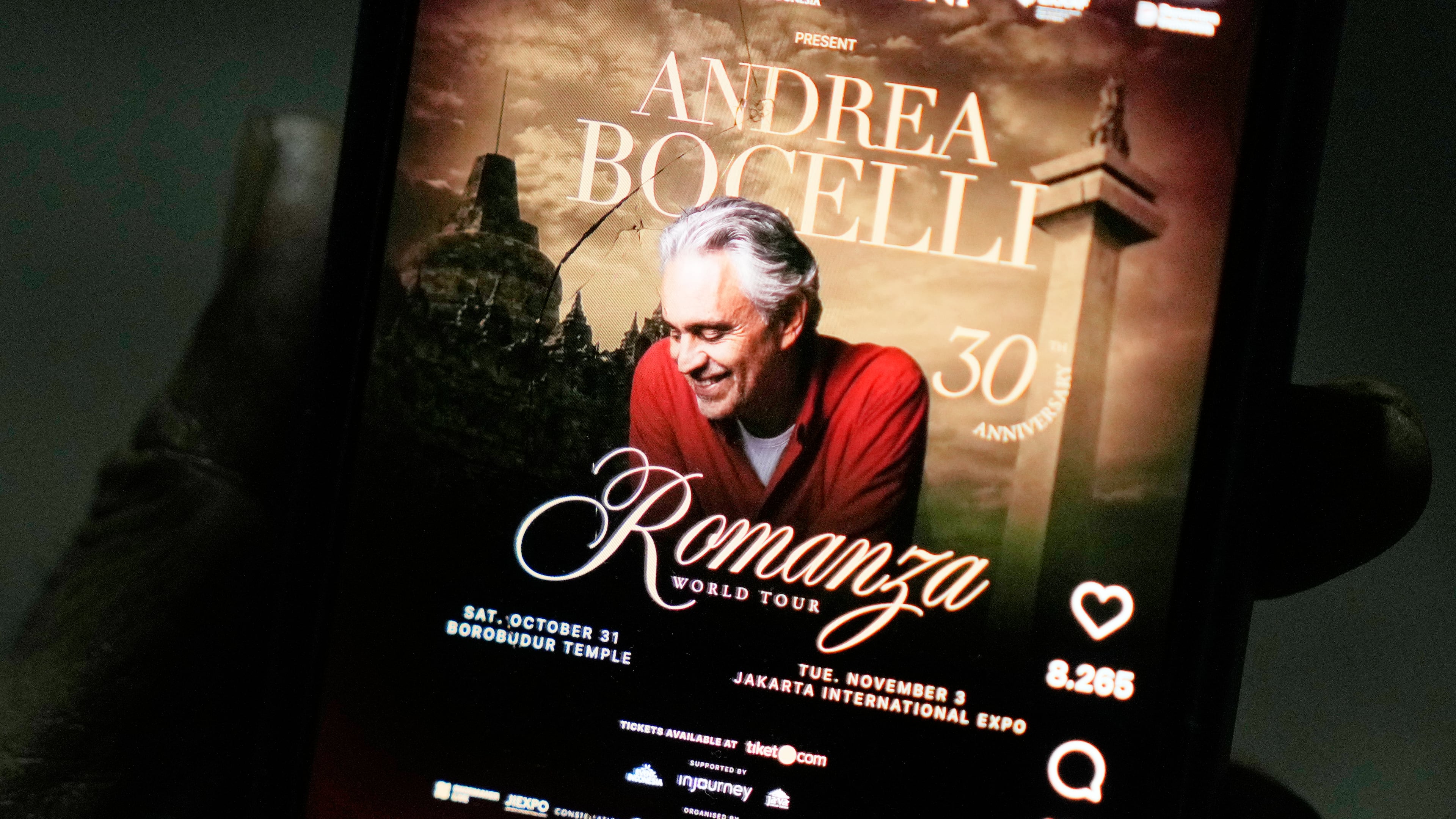 A man shows a social media promotional post for concerts by Italian tenor Andrea Bocelli on a mobile phone, in Jakarta, Indonesia, Wednesday, Oct. 14, 2026. (AP Photo/Dita Alangkara)