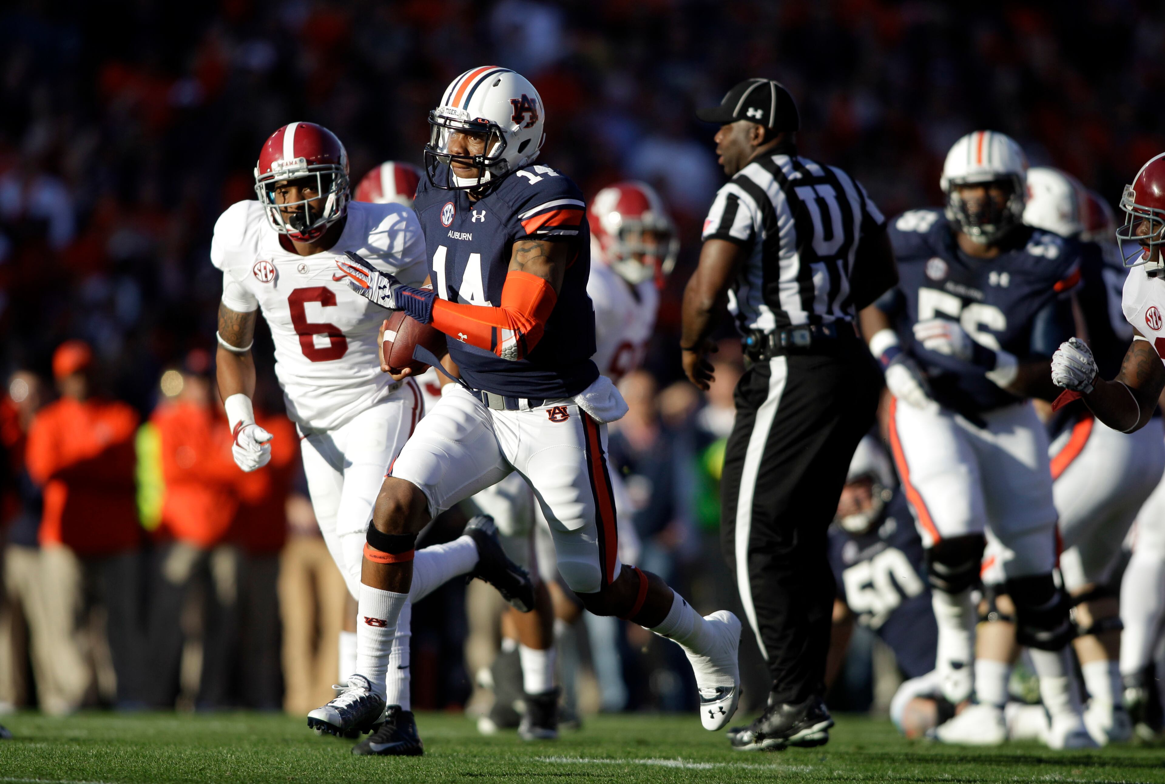 Auburn Tigers quarterback Nick Marshall (14) runs for a 45 yard touch down against Alabama Crimson Tide defensive back Ha Ha Clinton-Dix (6) during the first quarter at Jordan Hare Stadium.