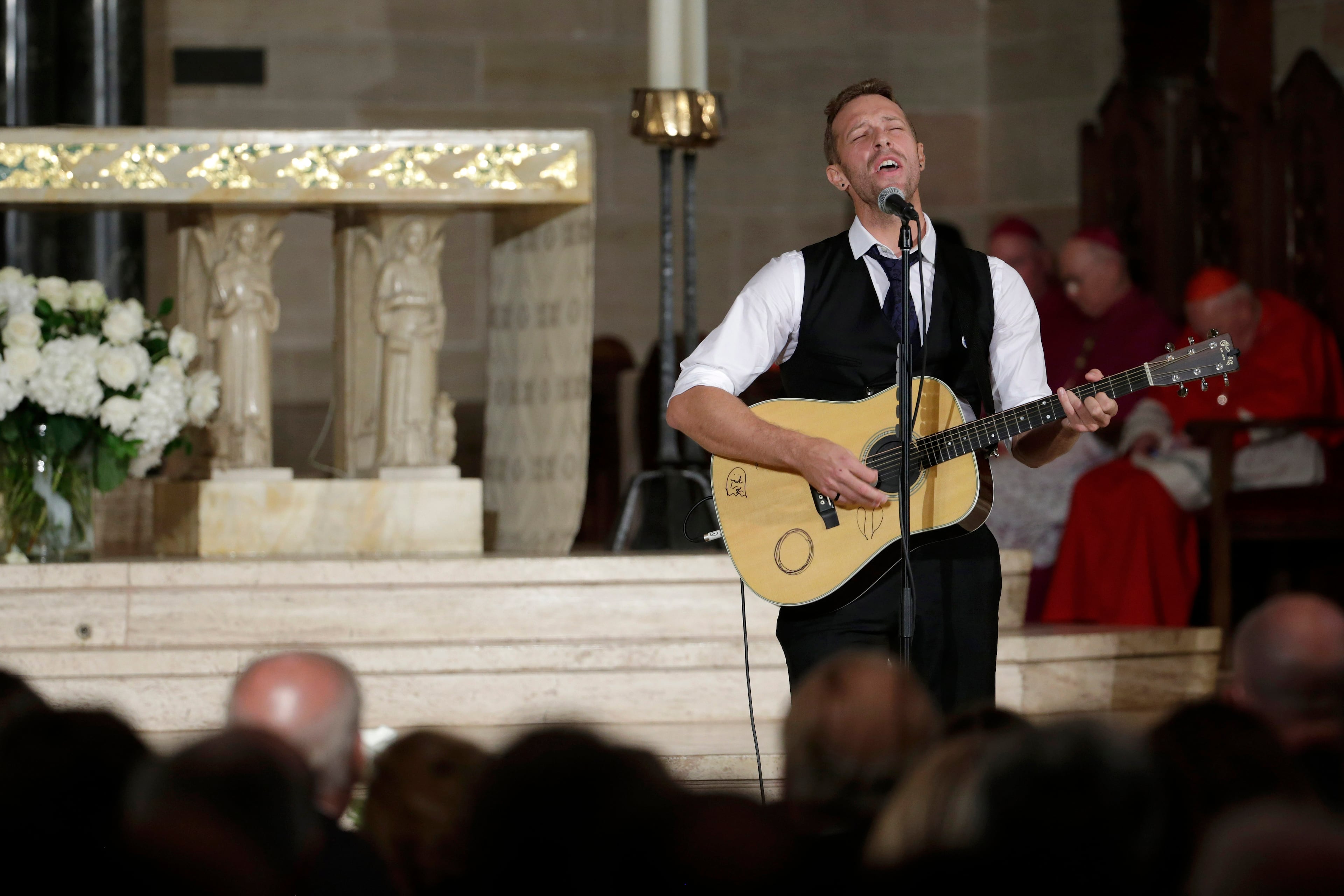 Chris Martin on the group Coldplay performs "Til Kingdom Comes" during funeral services for Vice President Joe Biden's son, former Delaware Attorney General Beau Biden, Saturday, June 6, 2015, at St. Anthony of Padua Church in Wilmington, Del. Vice President Joe Biden's eldest son, died at the age of 46 after a battle with brain cancer. (AP Photo/Pablo Martinez Monsivais, Pool)