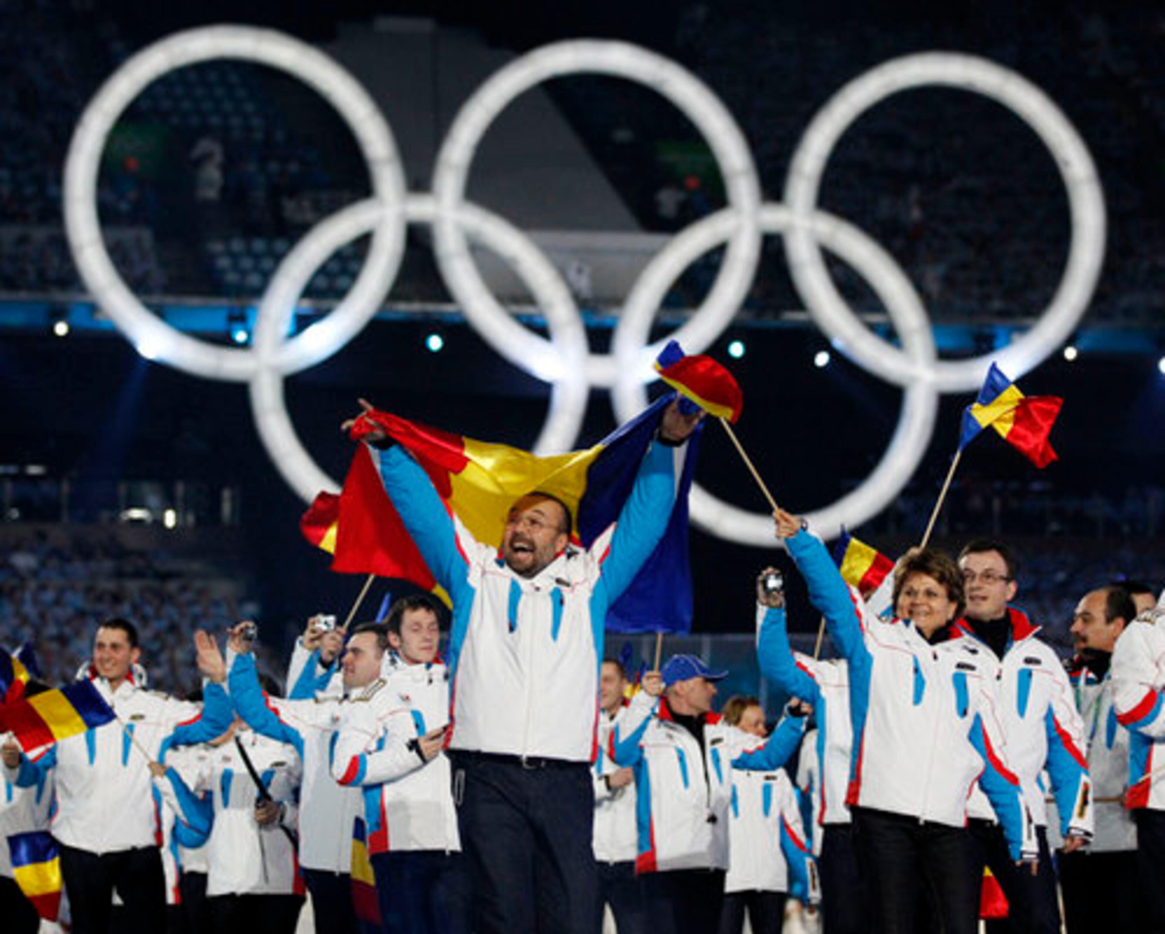 Romanian athletes wave to the crowd.