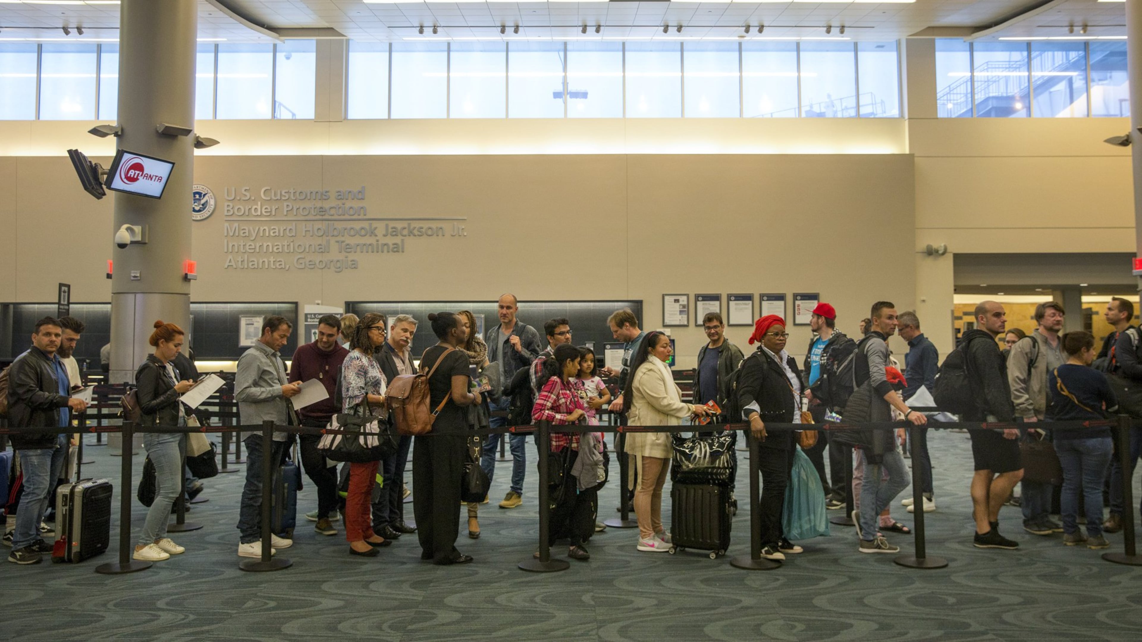 People wait in line at U.S. Customs and Border Protection at Hartsfield-Jackson Atlanta International Airport on May 2, 2018. ALYSSA POINTER/ALYSSA.POINTER@AJC.COM