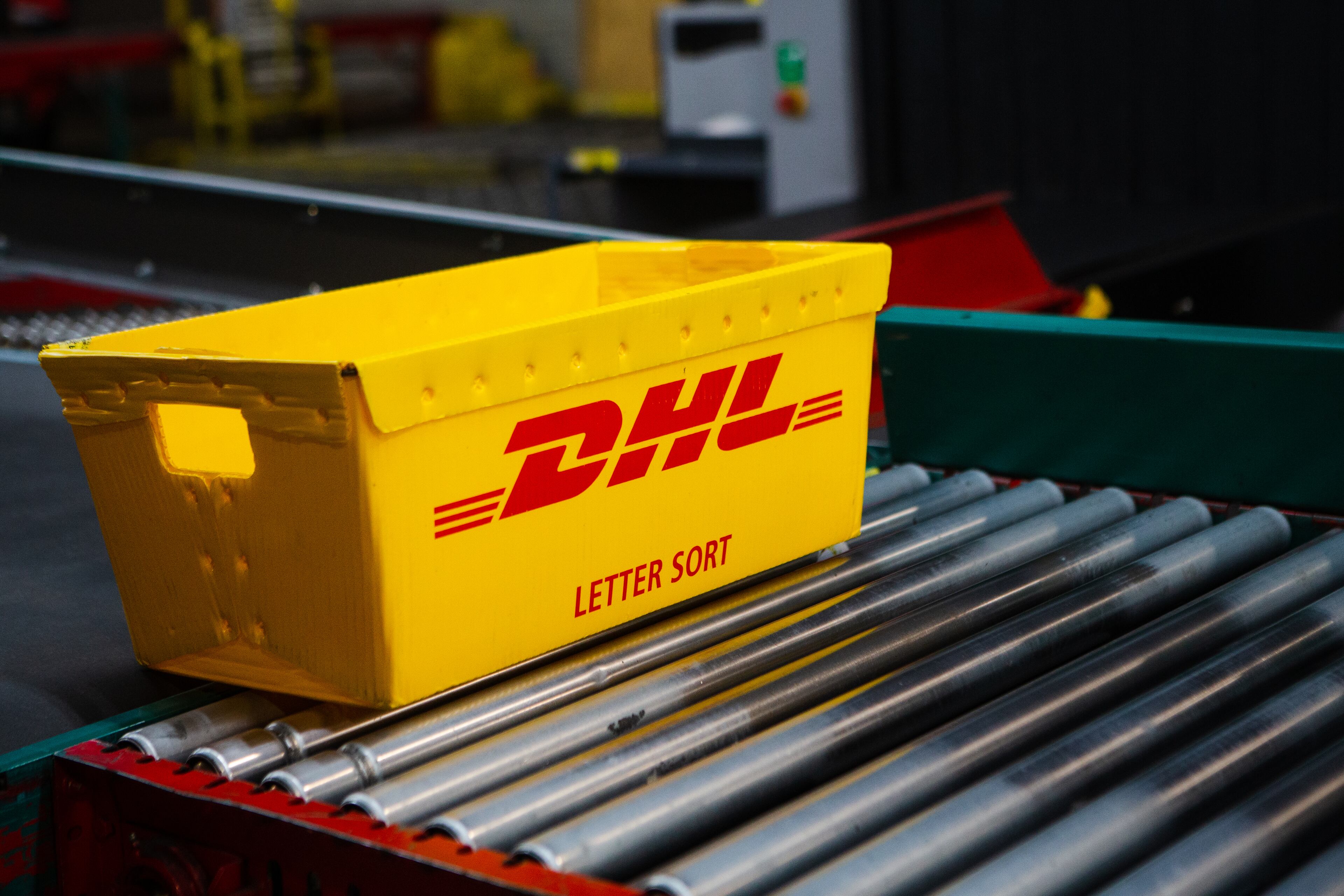 A DHL box is sent down the conveyer belt on Wednesday, December 16, 2020, at DHL Express in Atlanta. Workers at the shipping center worked to fulfill orders during the holiday rush. CHRISTINA MATACOTTA FOR THE ATLANTA JOURNAL-CONSTITUTION.