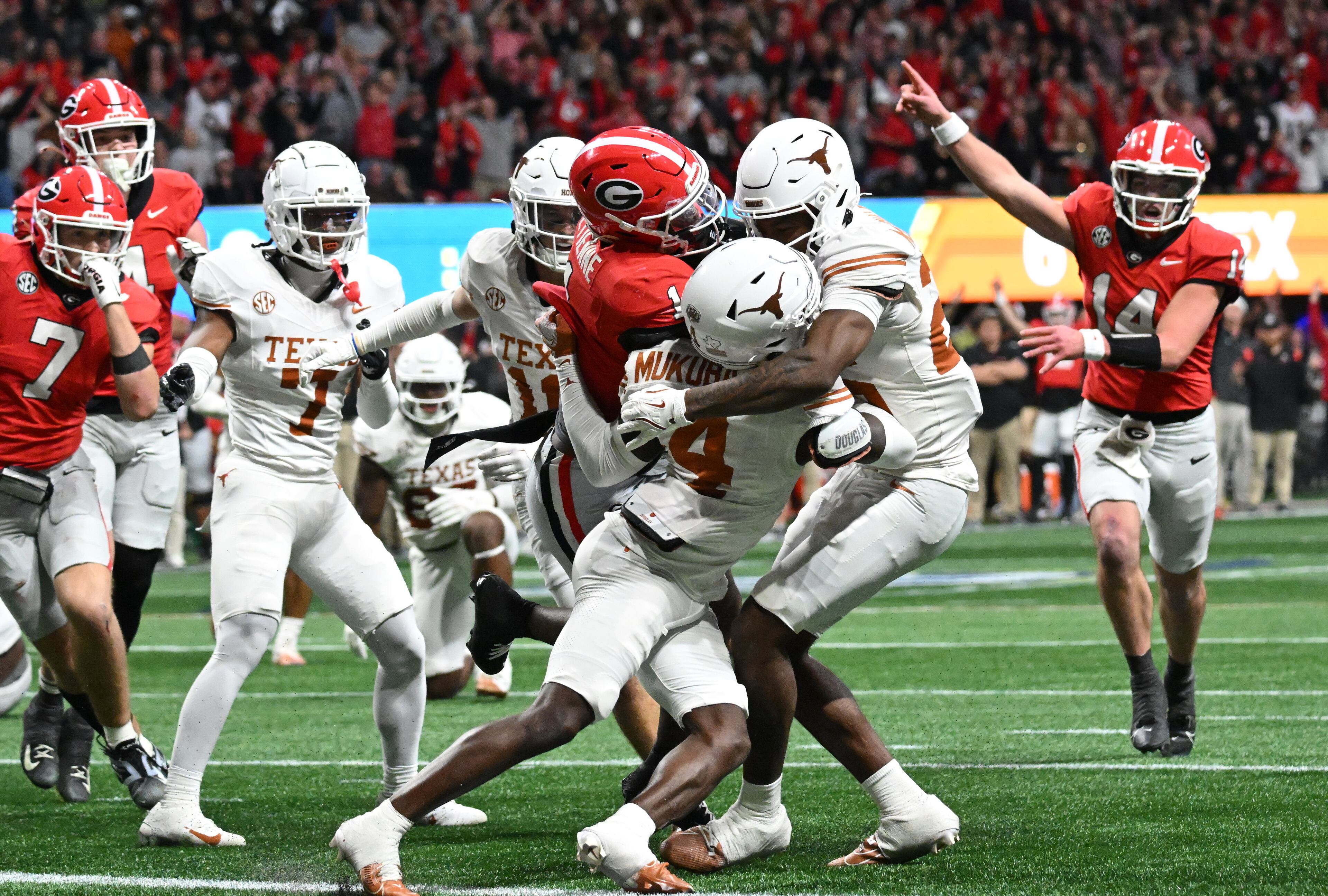 Georgia running back Trevor Etienne (1) pushes for a touchdown during the second half in the SEC Championship football game at the Mercedes-Benz Stadium, Saturday, December 7, 2024, in Atlanta. Georgia won 22-19 over Texas in overtime. (Hyosub Shin / AJC)