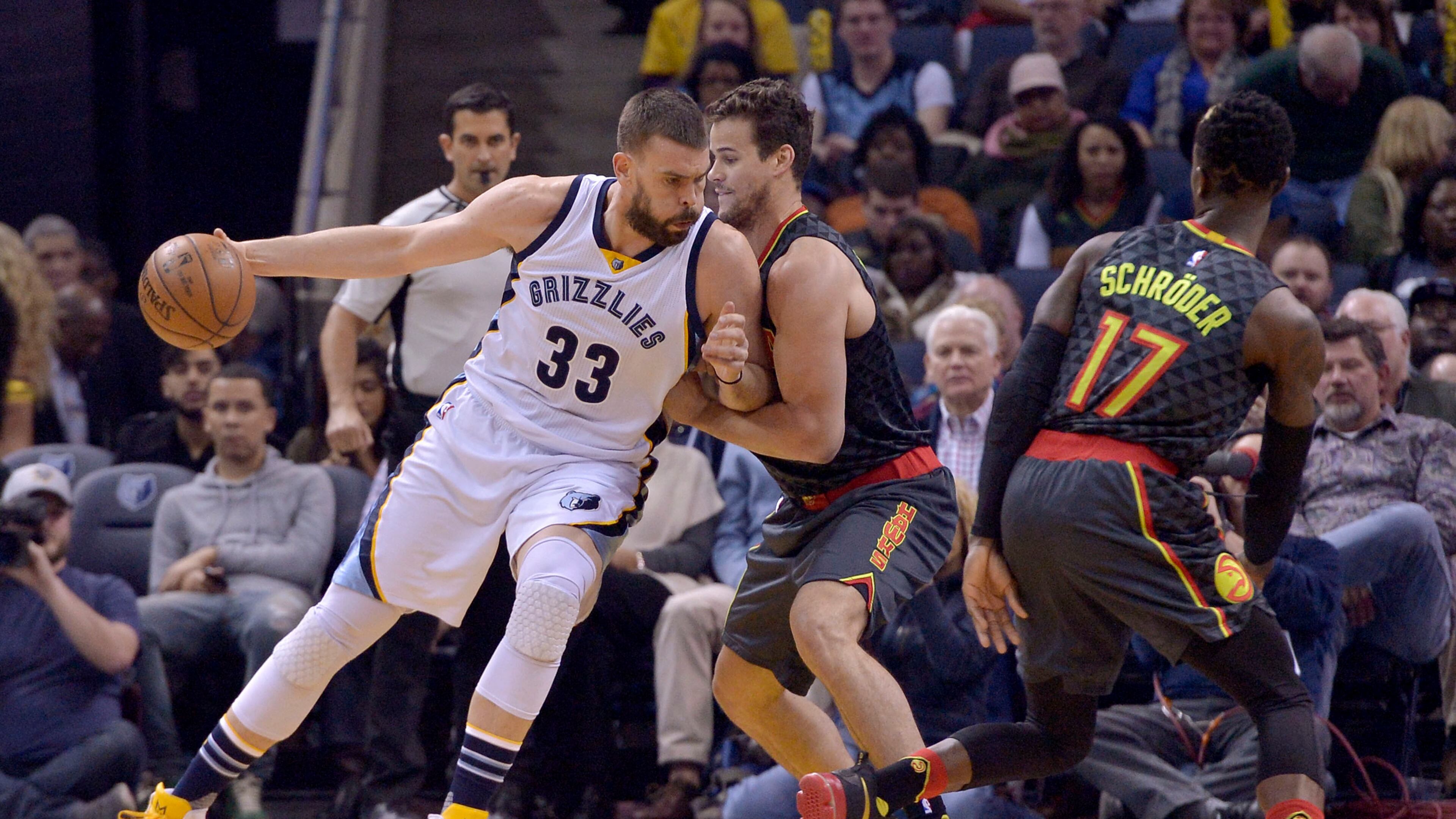 Memphis Grizzlies center Marc Gasol (33) controls the ball against Atlanta Hawks forward Kris Humphries, center, and guard Dennis Schroder (17) in the first half of an NBA basketball game Saturday, March 11, 2017, in Memphis, Tenn. (AP Photo/Brandon Dill)