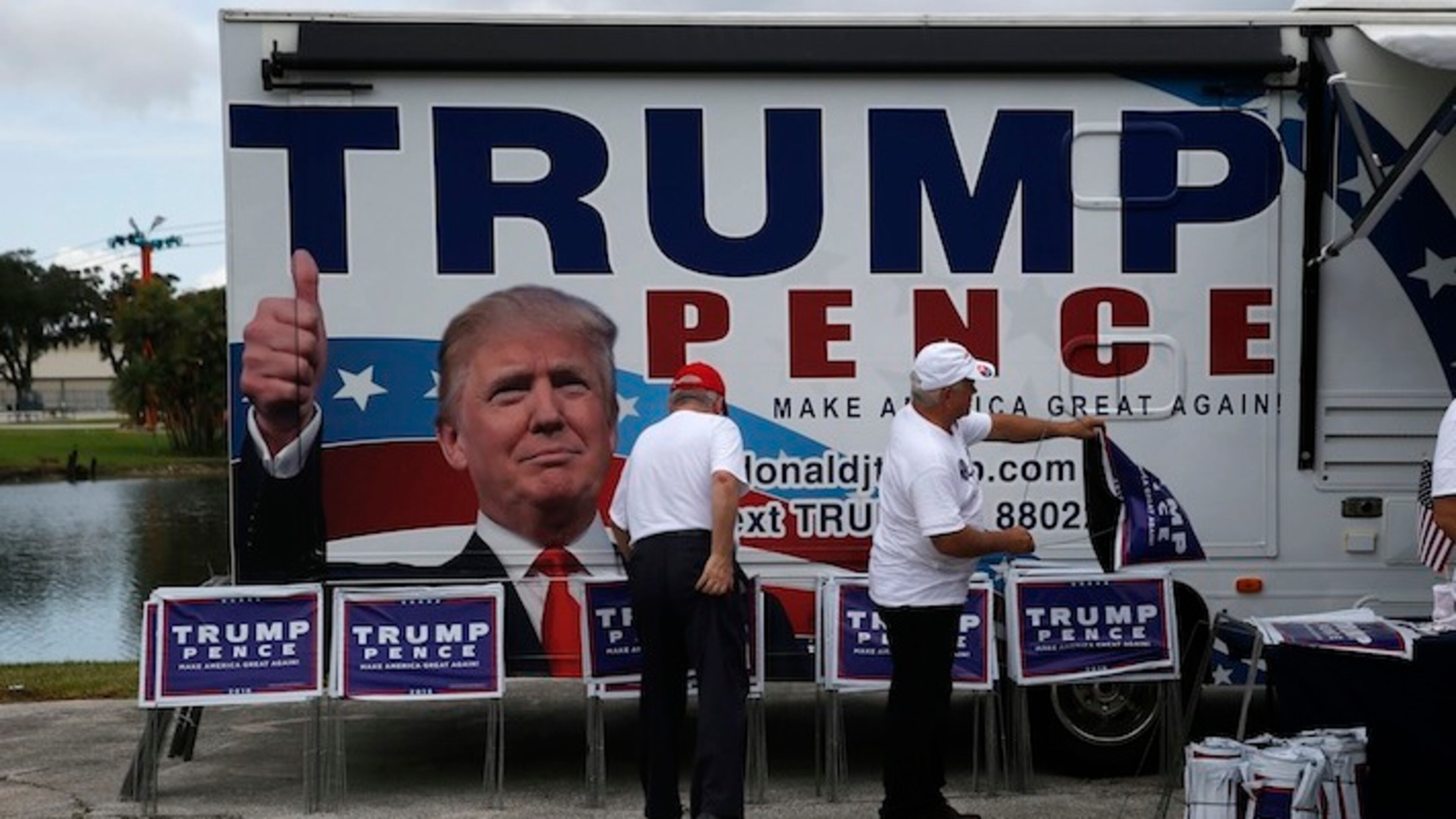 Campaign volunteers ready signs before Republican presidential candidate Donald Trump speaks at a campaign rally in Tampa, Wednesday, Aug. 24, 2016. (AP Photo/Gerald Herbert)