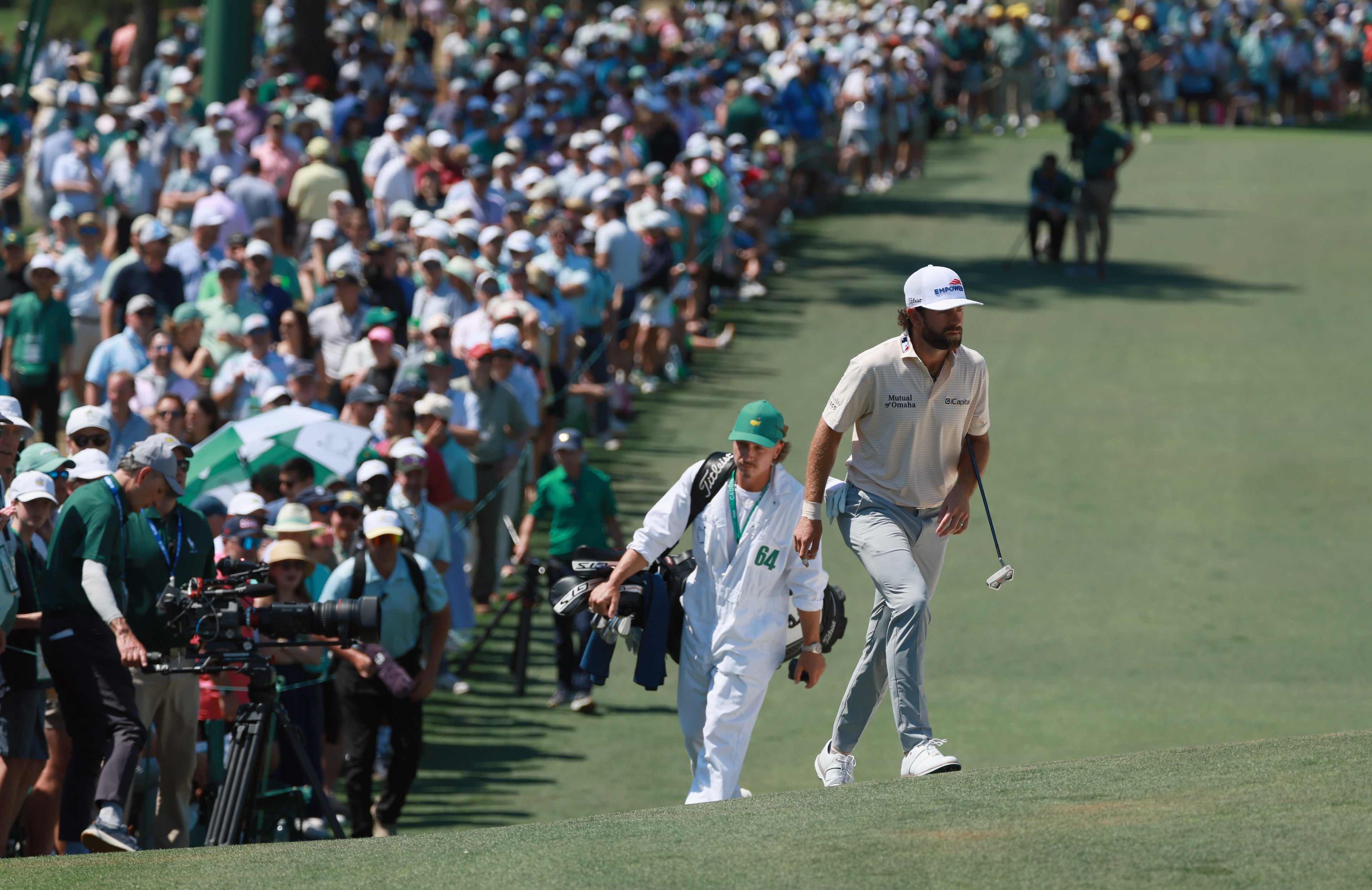 Cameron Young and Kyle Sterbinsky head to second green during final round of the Masters, at Augusta National Golf Club, Sunday, April 12, 2026, in Augusta, GA (Jason Getz/AJC)