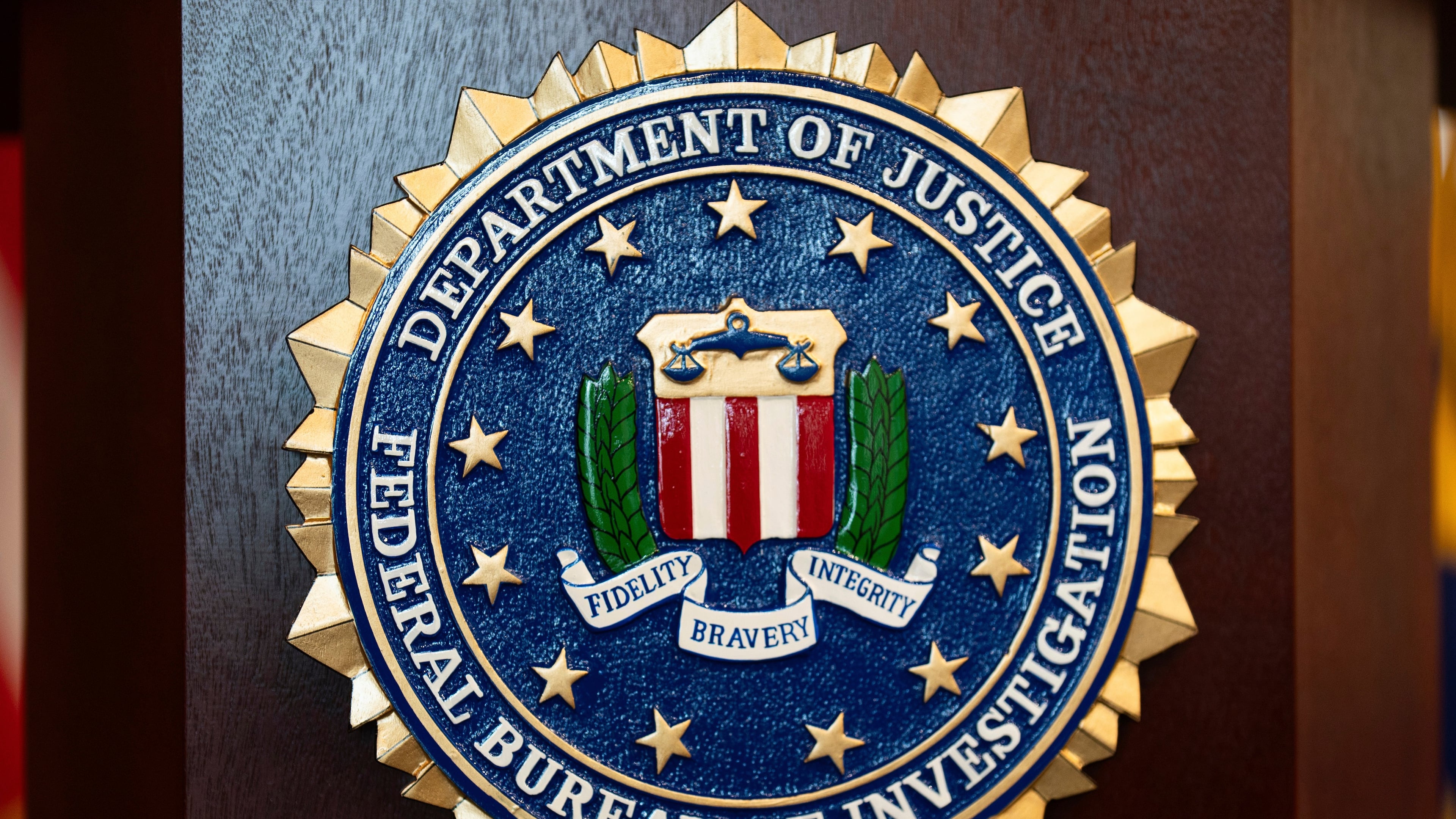 FILE - An FBI seal is displayed on a podium before a news conference at the field office in Portland, Ore., Jan. 16, 2025. (AP Photo/Jenny Kane, File)