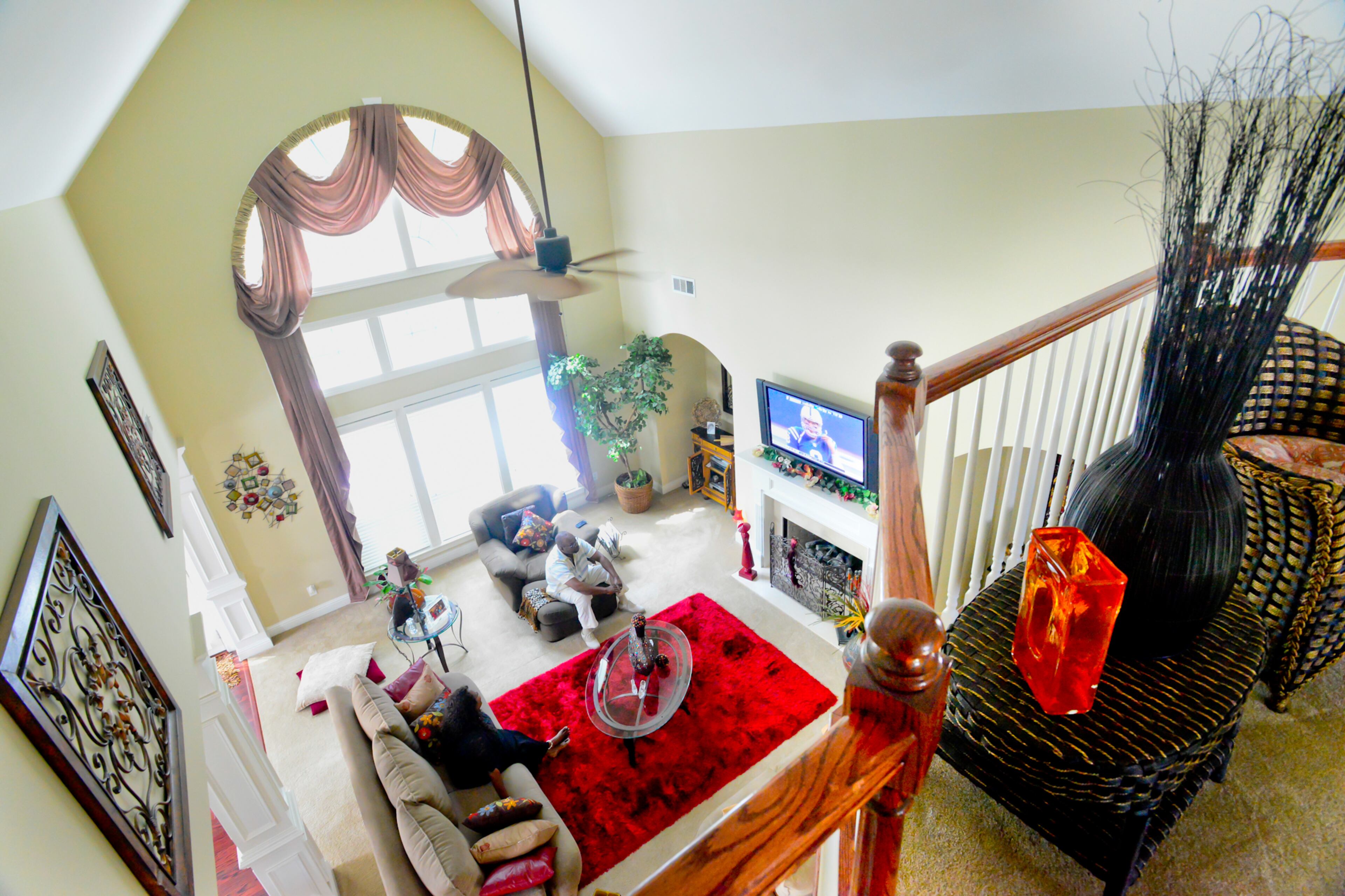 The window wall in the two-story family room sold Frances Pace on this Ellenwood home. The arch of the windows mimics the arch to the right, and the family room also features columns created by Ryland Homes.