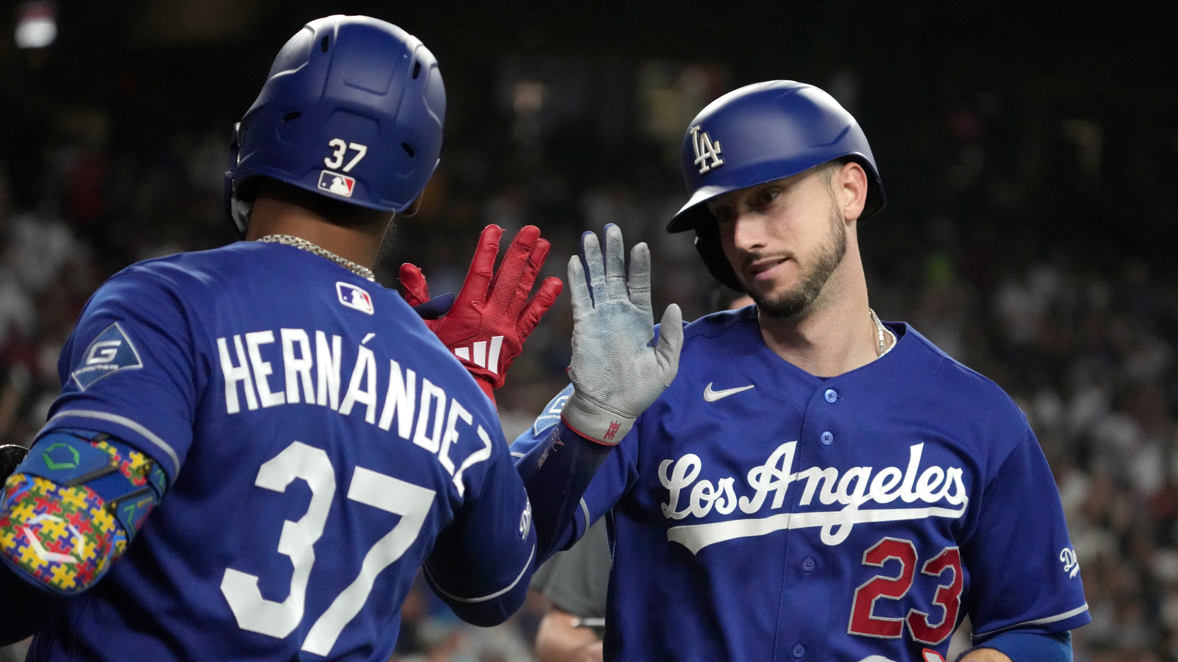 Los Angeles Dodgers' Kyle Tucker celebrates with Teoscar Hernández (37) after hitting a solo home run against the Arizona Diamondbacks in the eighth inning of a baseball game, Saturday, Aug. 8, 2026, in Phoenix. (AP Photo/Rick Scuteri)
