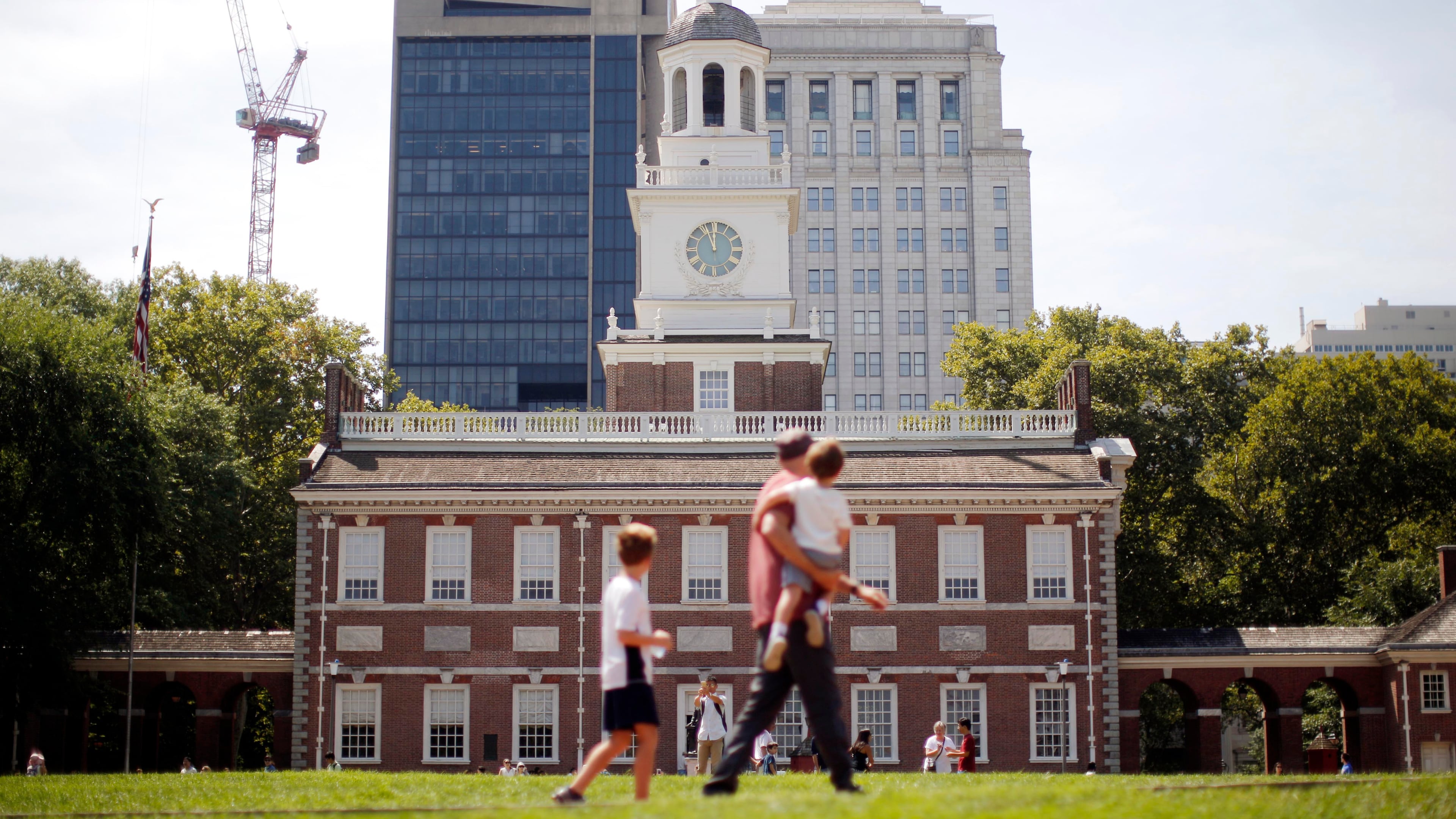 FILE- People move past Independence Hall at the Independence National Historical Park in Philadelphia, Aug. 25, 2016. (AP Photo/Matt Rourke, File)