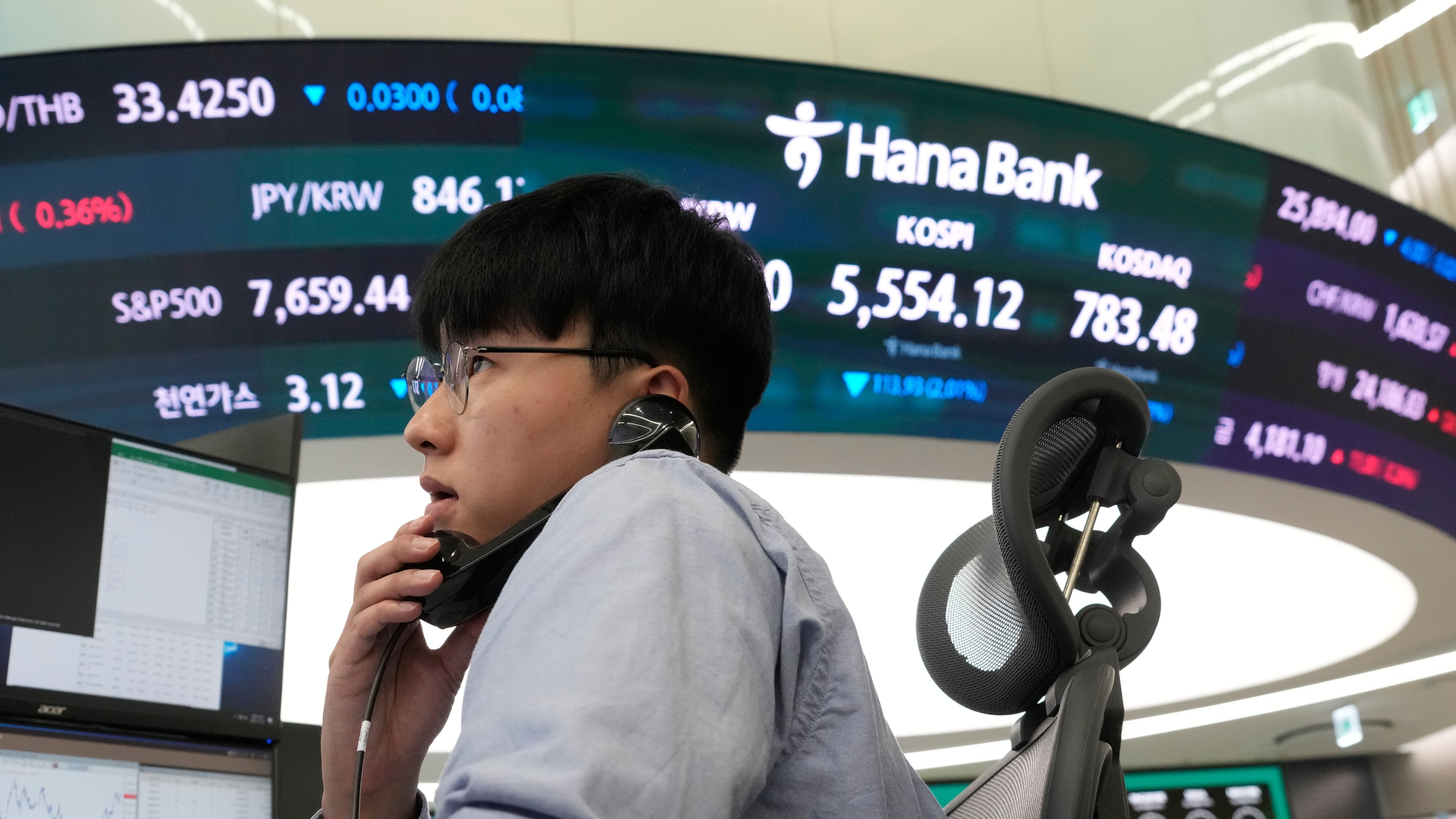 A currency trader talks on the phone at the foreign exchange dealing room of the Hana Bank headquarters in Seoul, South Korea, Monday, Oct. 19, 2026. (AP Photo/Ahn Young-joon)
