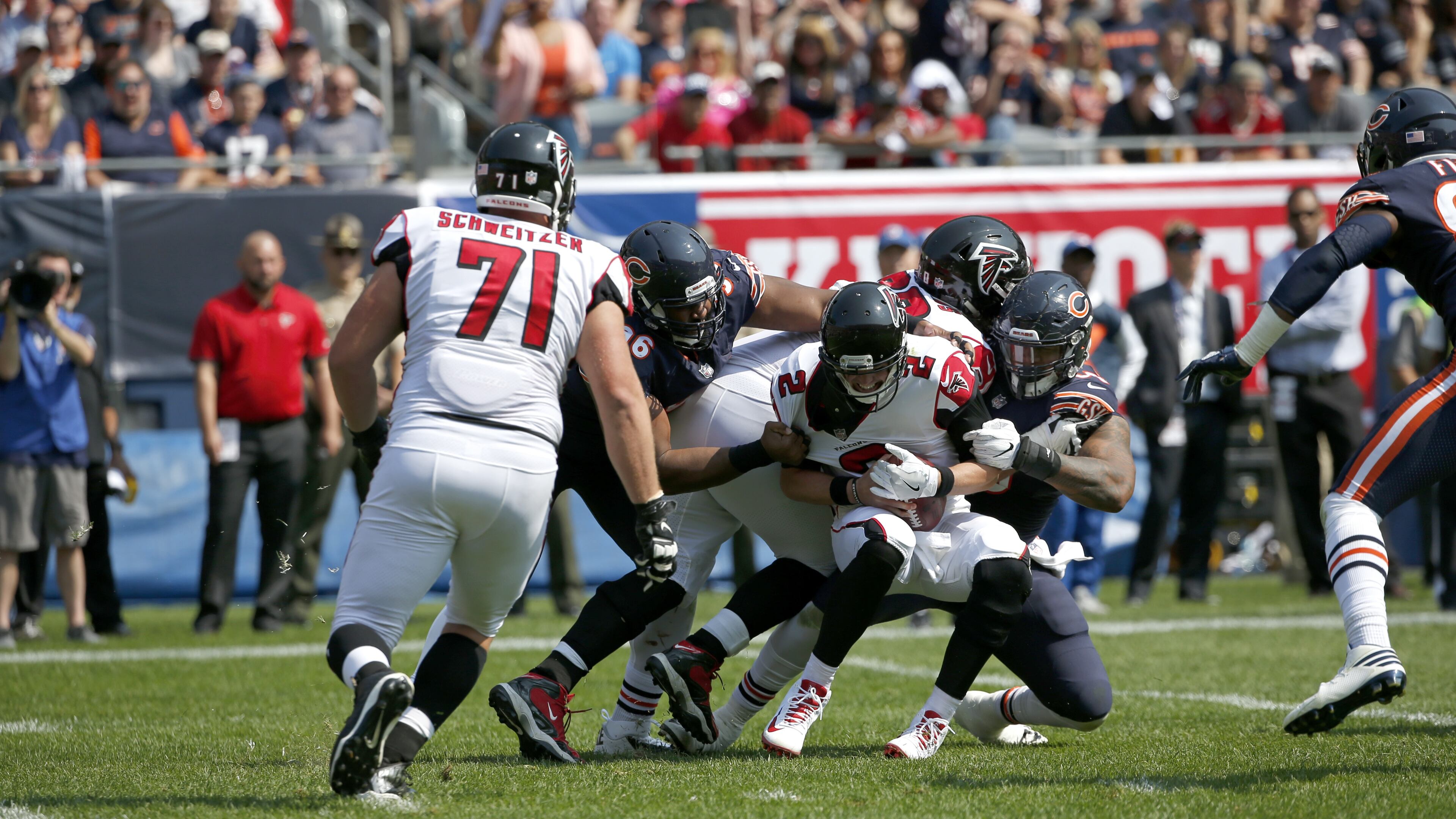 Atlanta Falcons quarterback Matt Ryan (2) is tackled by Chicago Bears defensive ends Akiem Hicks (96) and Roy Robertson-Harris (95) during the second half of an NFL football game, Sunday, Sept. 10, 2017, in Chicago. Right guard Wes Schweitzer was victimized on the play. (AP Photo/Nam Y. Huh)