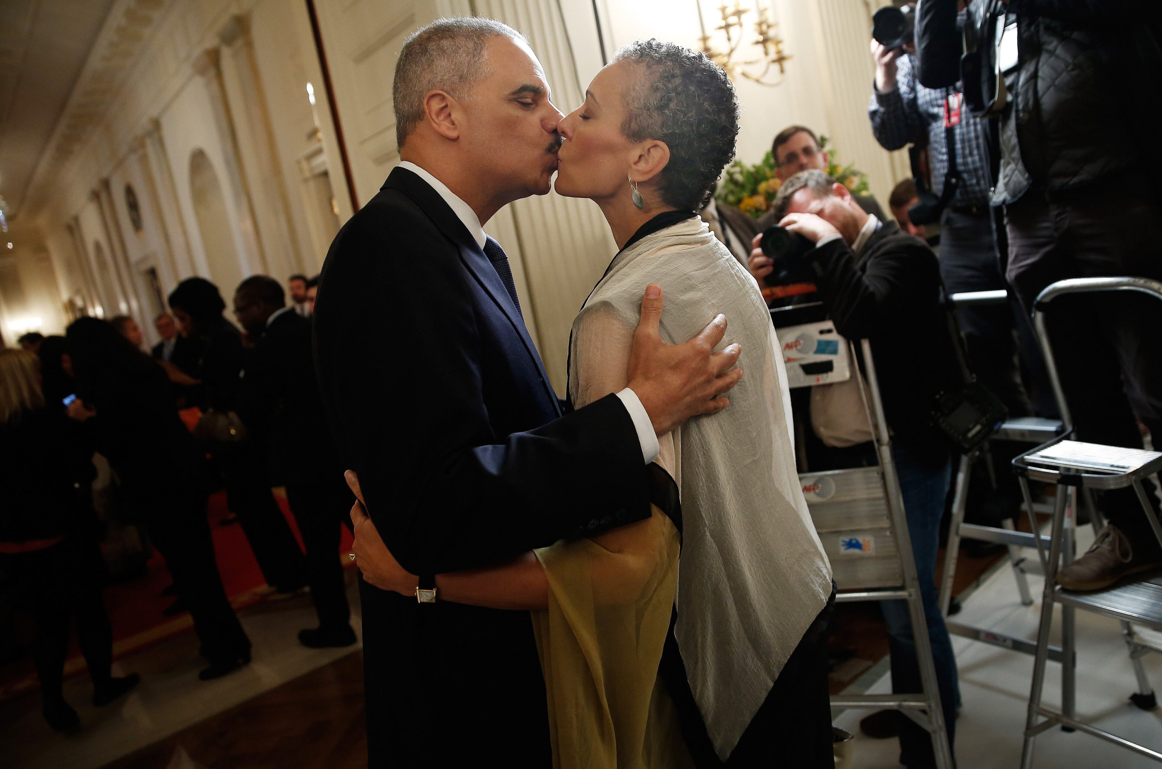 WASHINGTON, DC - SEPTEMBER 25: U.S. Attorney General Eric Holder (L) kisses his wife, Sharon Malone (R), after announcing his resignation at the White House September 25, 2014 in Washington, DC. Holder has been led the Department of Justice since the beginning of the Obama administration in 2009 and plans to remain in office until his successor is named. (Photo by Win McNamee/Getty Images)