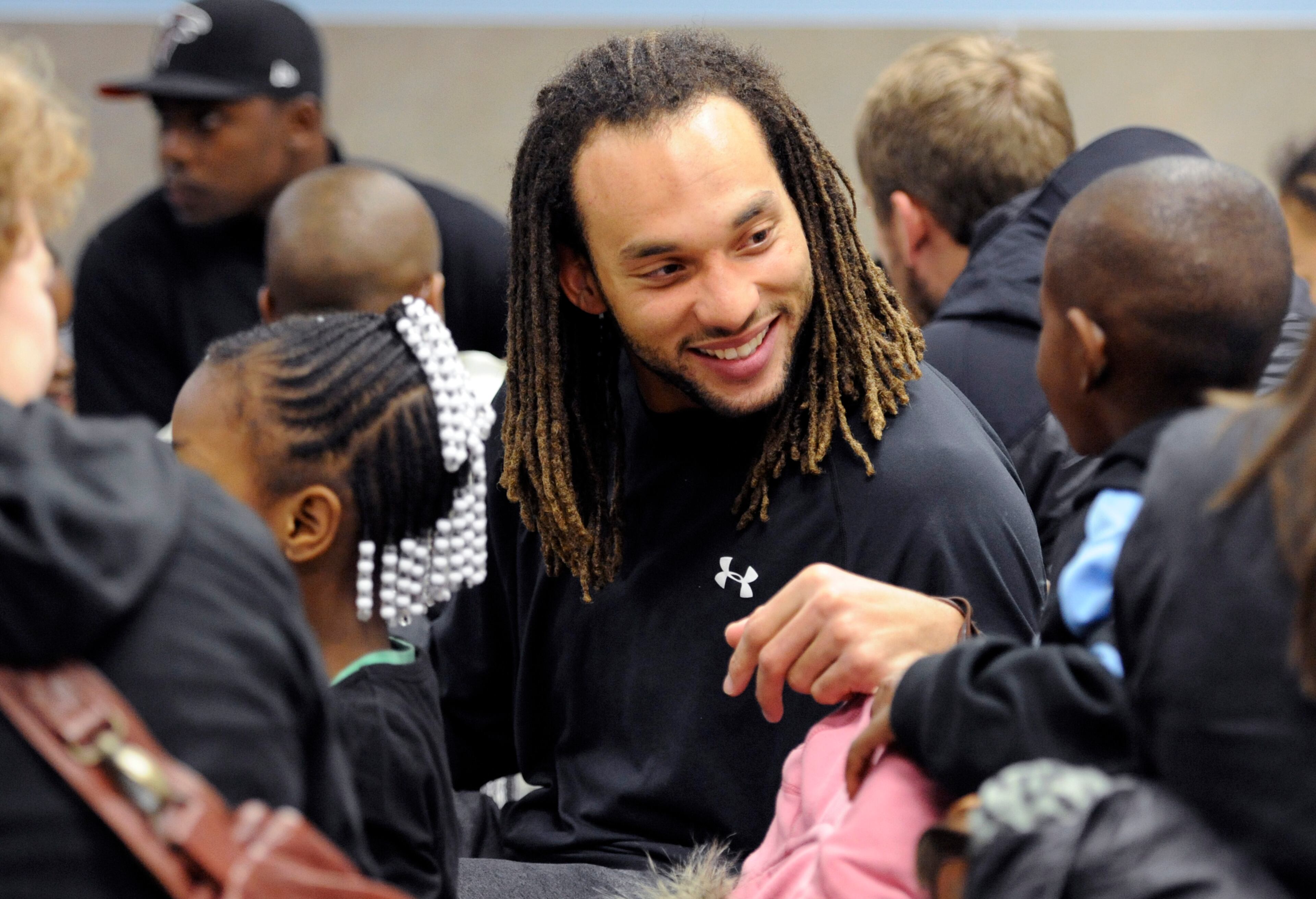 Atlanta Falcons wide receiver Kevin Cone eats with kids before taking them shopping at Wal-Mart Tuesday, Dec. 11, 2012, in Suwanee. He and other Falcons players were participating in the program "Shop with a Jock" in which they provided 37 children from an Atlanta area mission with a $100 gift card and helped them shop.