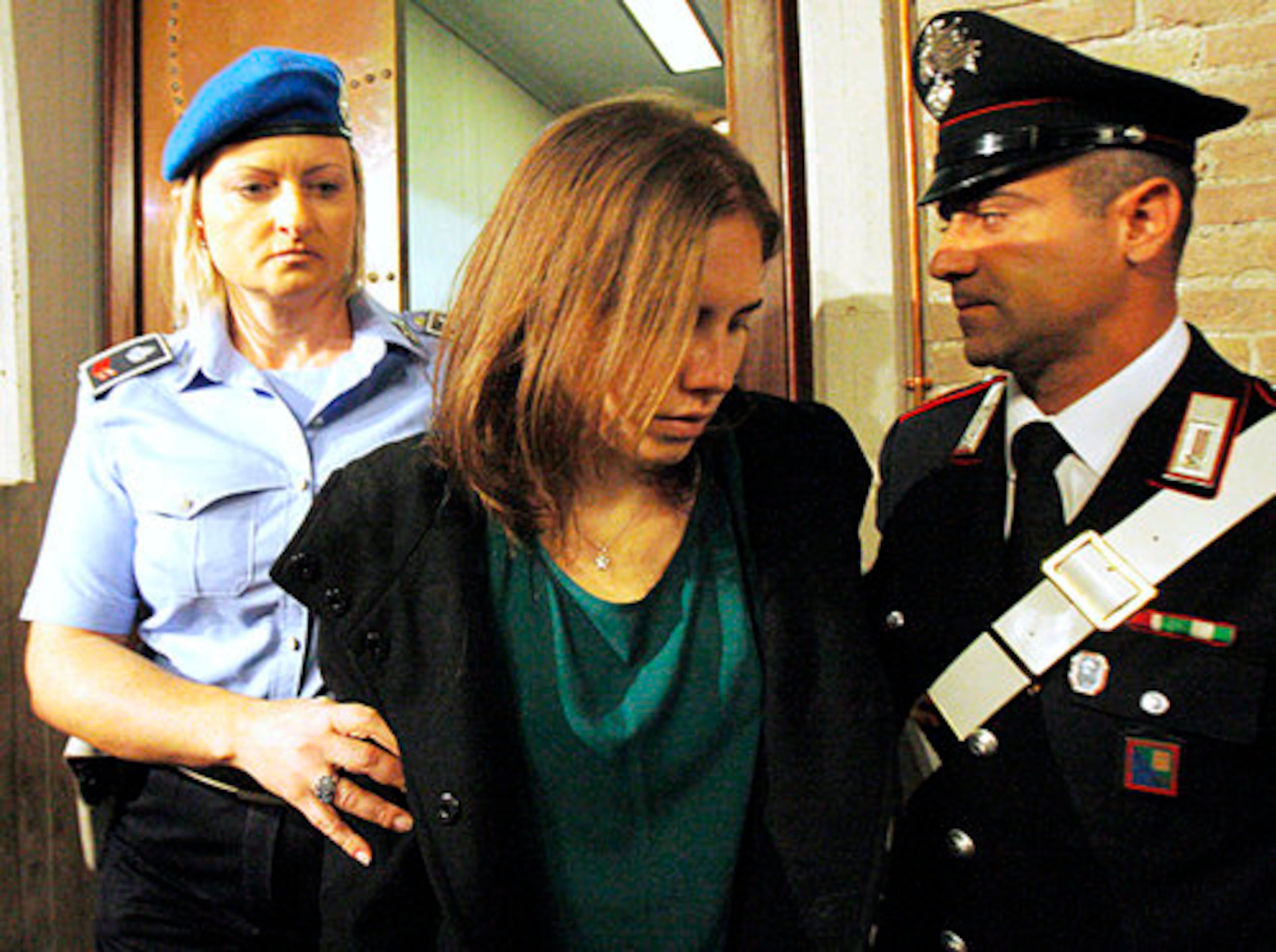 Amanda Knox, center, is escorted as she arrives for an appeal hearing at the Perugia court. The American and Raffaele Sollecito are appealing their 2009 convictions in the death of Meredith Kercher. Kercher was Knox's roommate at the time of the killing.