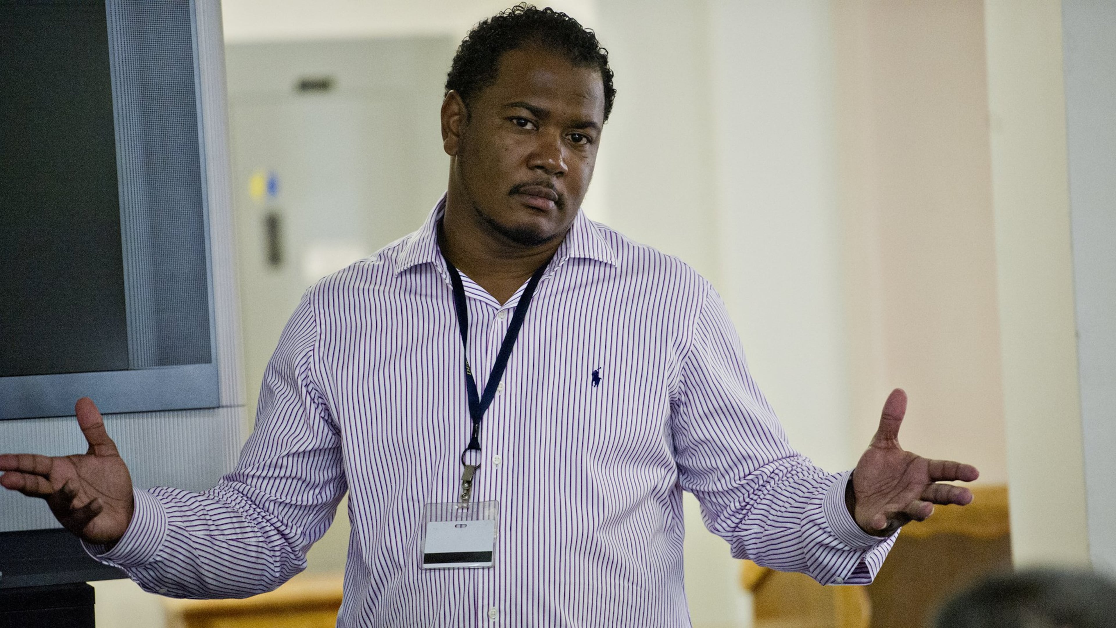 Omar Howard (shown in 2014) speaks with residents of the Atlanta Transitional Center. Howard, once an inmate in a correctional facility himself, is now a chaplain and motivational speaker. JONATHAN PHILLIPS / SPECIAL