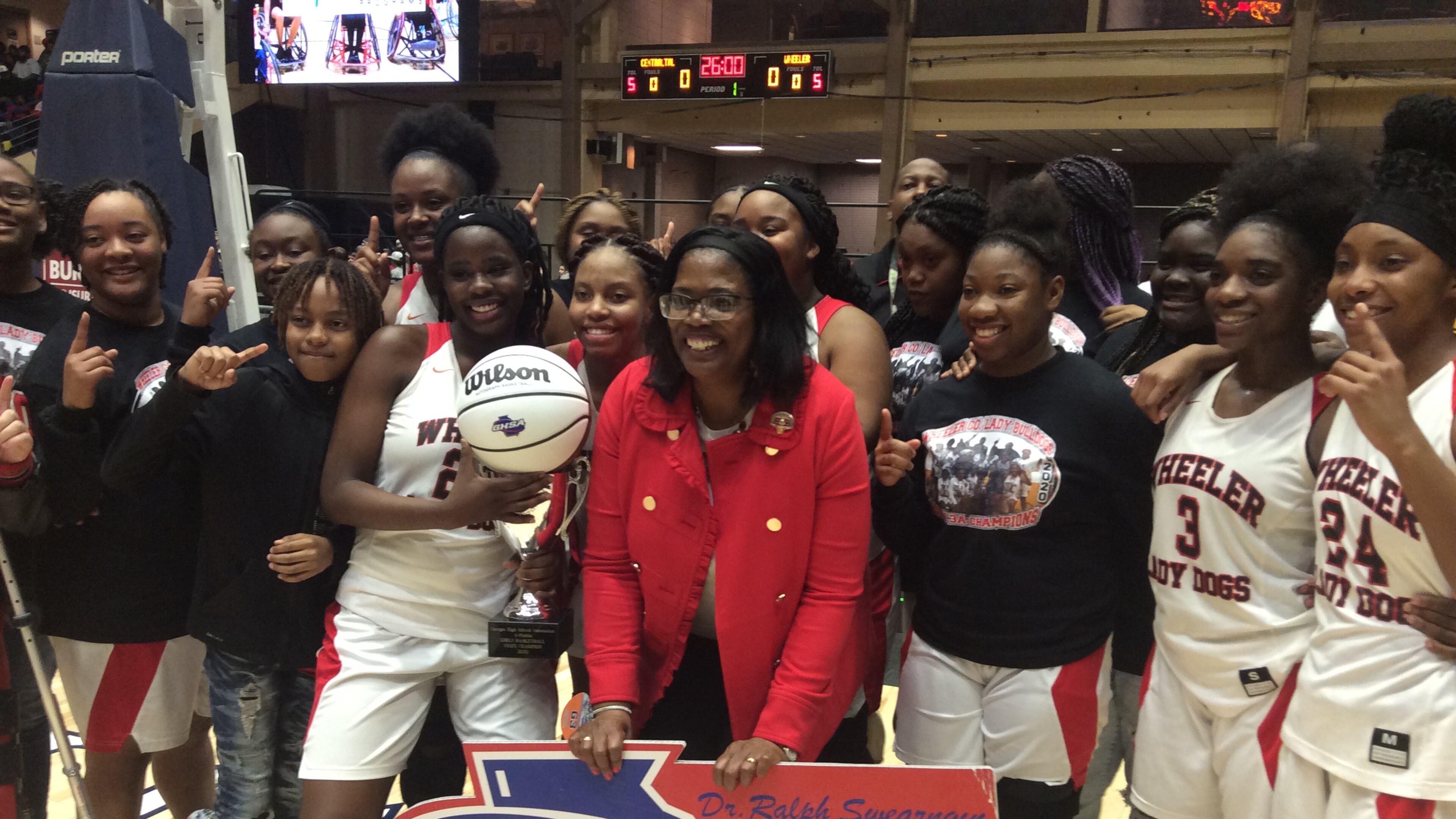 Coach Angelia Wright and the Wheeler County players celebrate the first girls basketball championship in school history on March 4, 2020, at the Macon Centreplex.