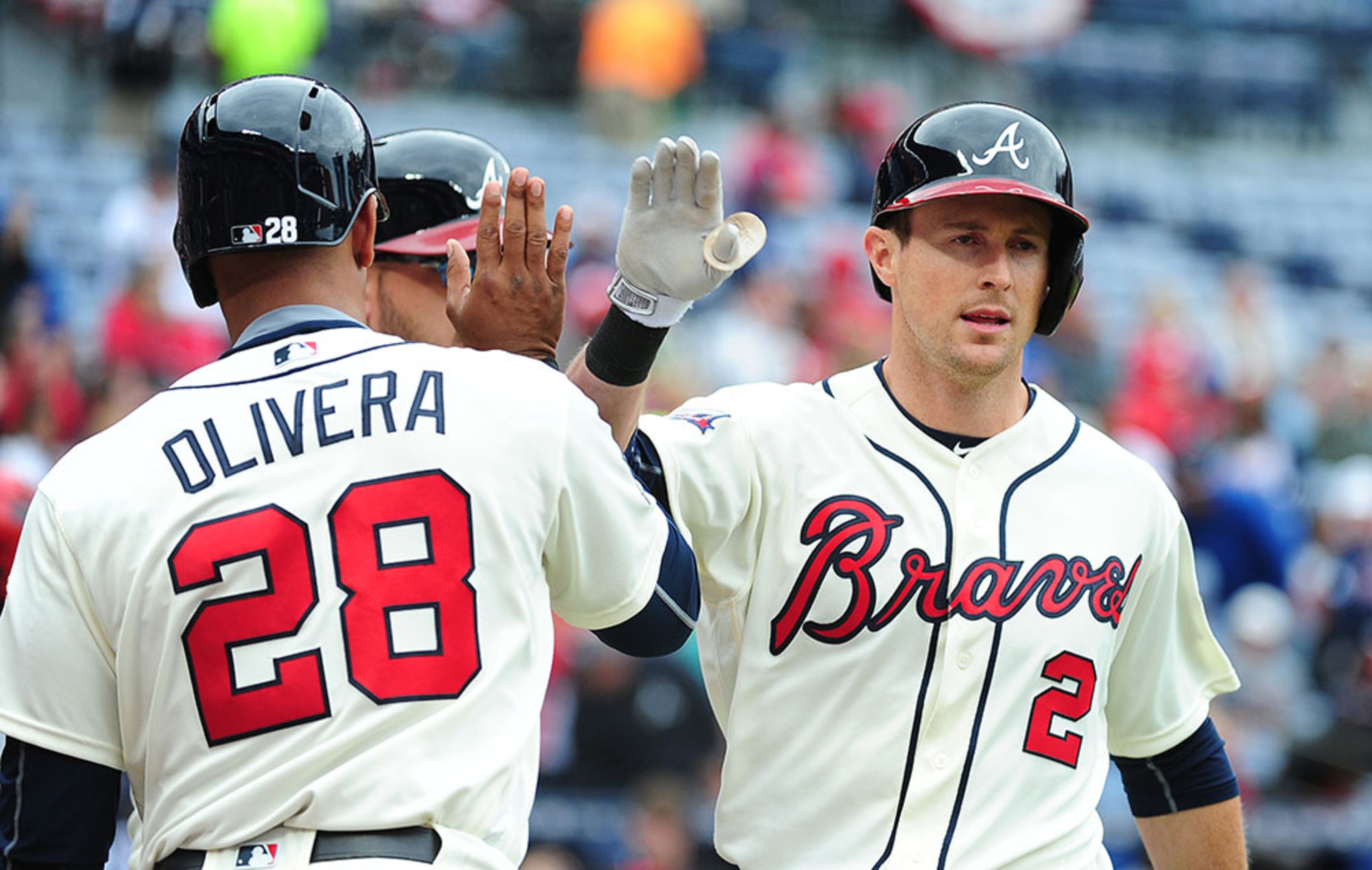 Drew Stubbs (2) of the Atlanta Braves is congratulated by teammate Hector Olivera (28) after hitting a fourth inning three-run home run against the St. Louis Cardinals at Turner Field on April 10, 2016 in Atlanta.
