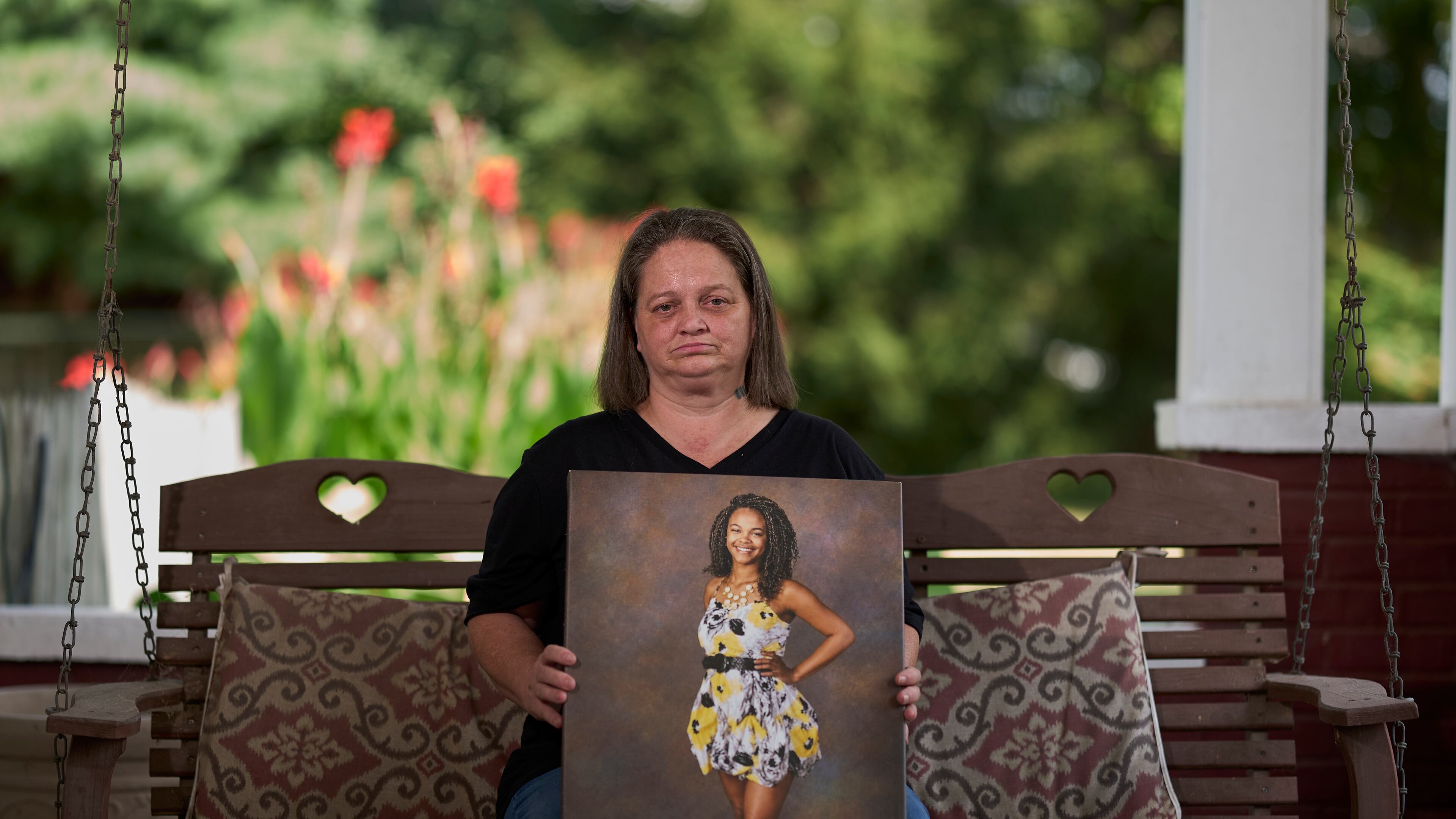 Christy Spivey poses with a portrait of her late daughter, Tasia Fortune, on Tuesday, Sept. 8, 2026, in Marion, Ky. (AP Photo/George Walker IV)
