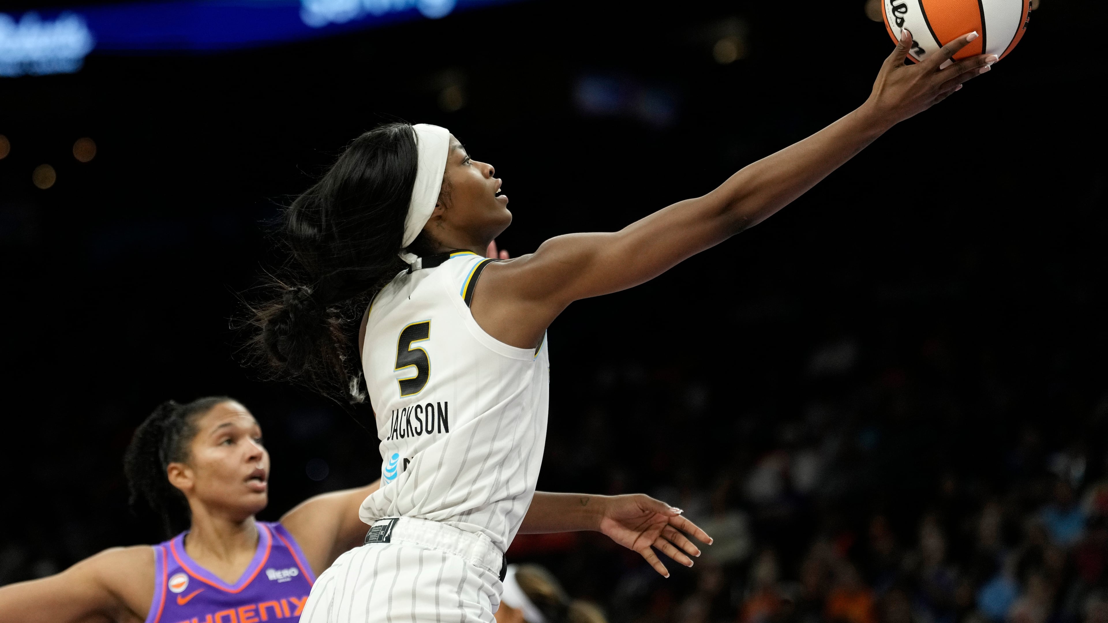 Chicago Sky forward Rickea Jackson (5) drives past Phoenix Mercury forward Alyssa Thomas to score during the second half of a WNBA basketball game, Friday, May 15, 2026, in Phoenix. (AP Photo/Ross D. Franklin)