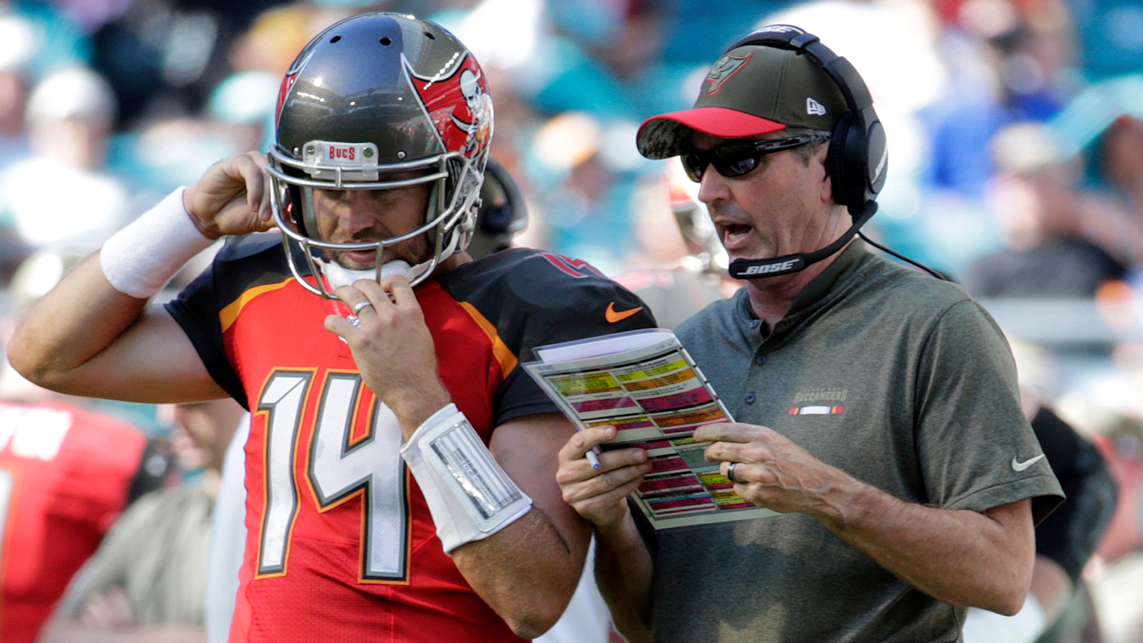 Tampa Bay Buccaneers head coach Dirk Koetter talks to quarterback Ryan Fitzpatrick (14) on the sidelins.