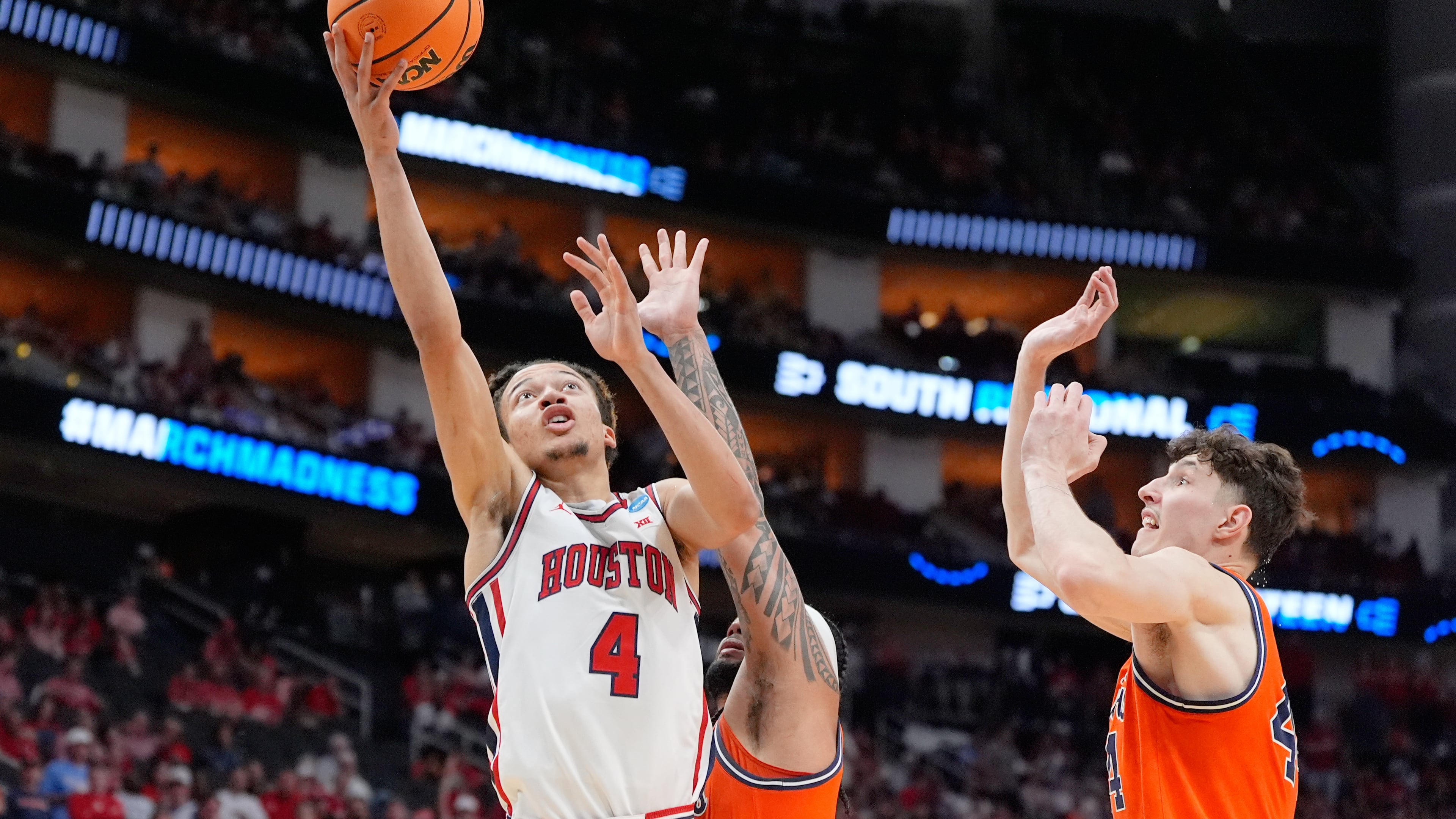 Houston guard Kingston Flemings (4) shoots past Illinois guard Kylan Boswell, center, and center Zvonimir Ivisic during the first half in the Sweet 16 of the NCAA college basketball tournament Thursday, March 26, 2026, in Houston. (AP Photo/Ashley Landis)