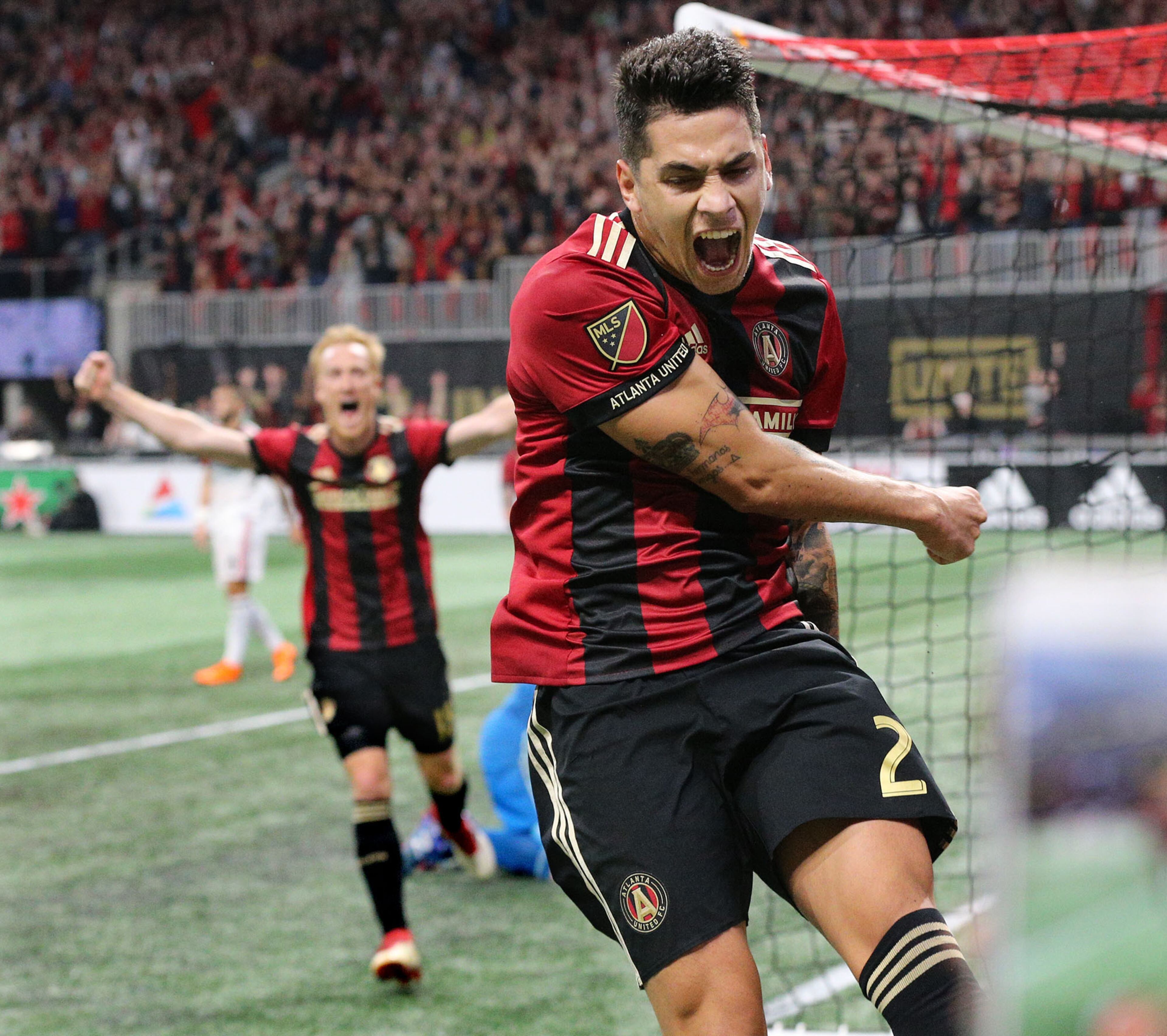 *** POSSIBLE VISUAL LEAD *** March 11, 2018 Atlanta: Atlanta United player Franco Escobar (right) and midfielder Jeff Larentowiz react as teammate Hector Villalba scores a goal against D.C. United for a 3-0 lead in the home opener during the second half in a MLS soccer match on Sunday, March 11, 2018, in Atlanta. Atlanta United won the game 3-1. Curtis Compton/ccompton@ajc.com