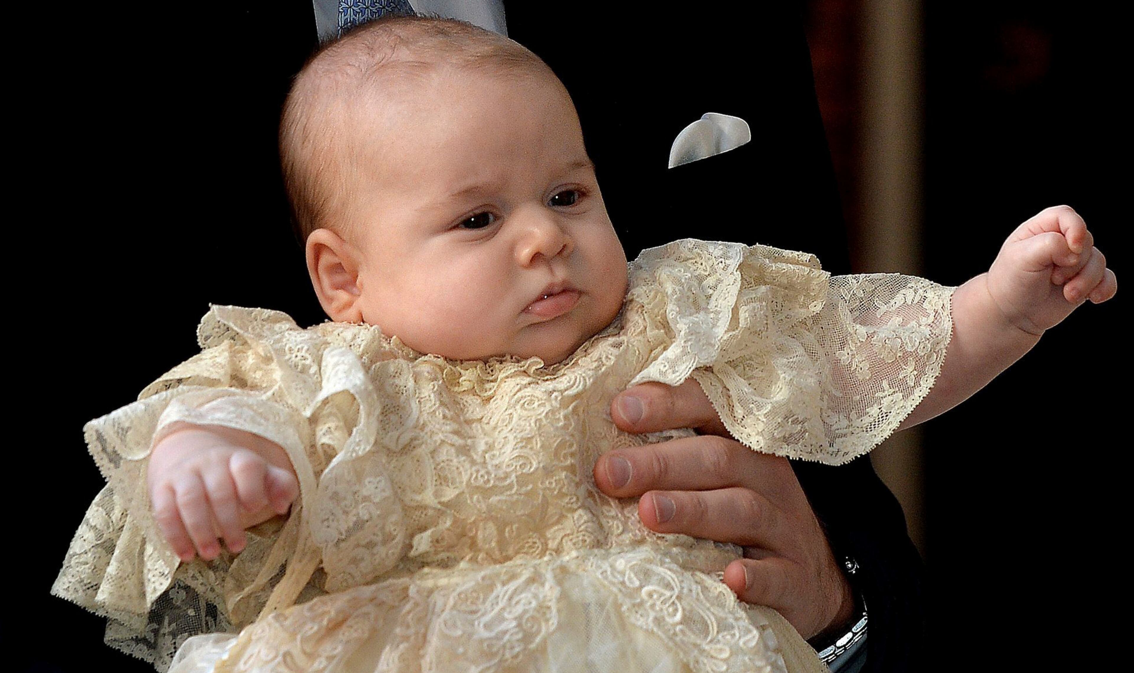 Britain's Prince George is held by his father Prince William as they arrive at Chapel Royal in St James's Palace in London, for the christening of the three month-old Prince Wednesday Oct. 23, 2013. (AP Photo/John Stillwell/Pool)