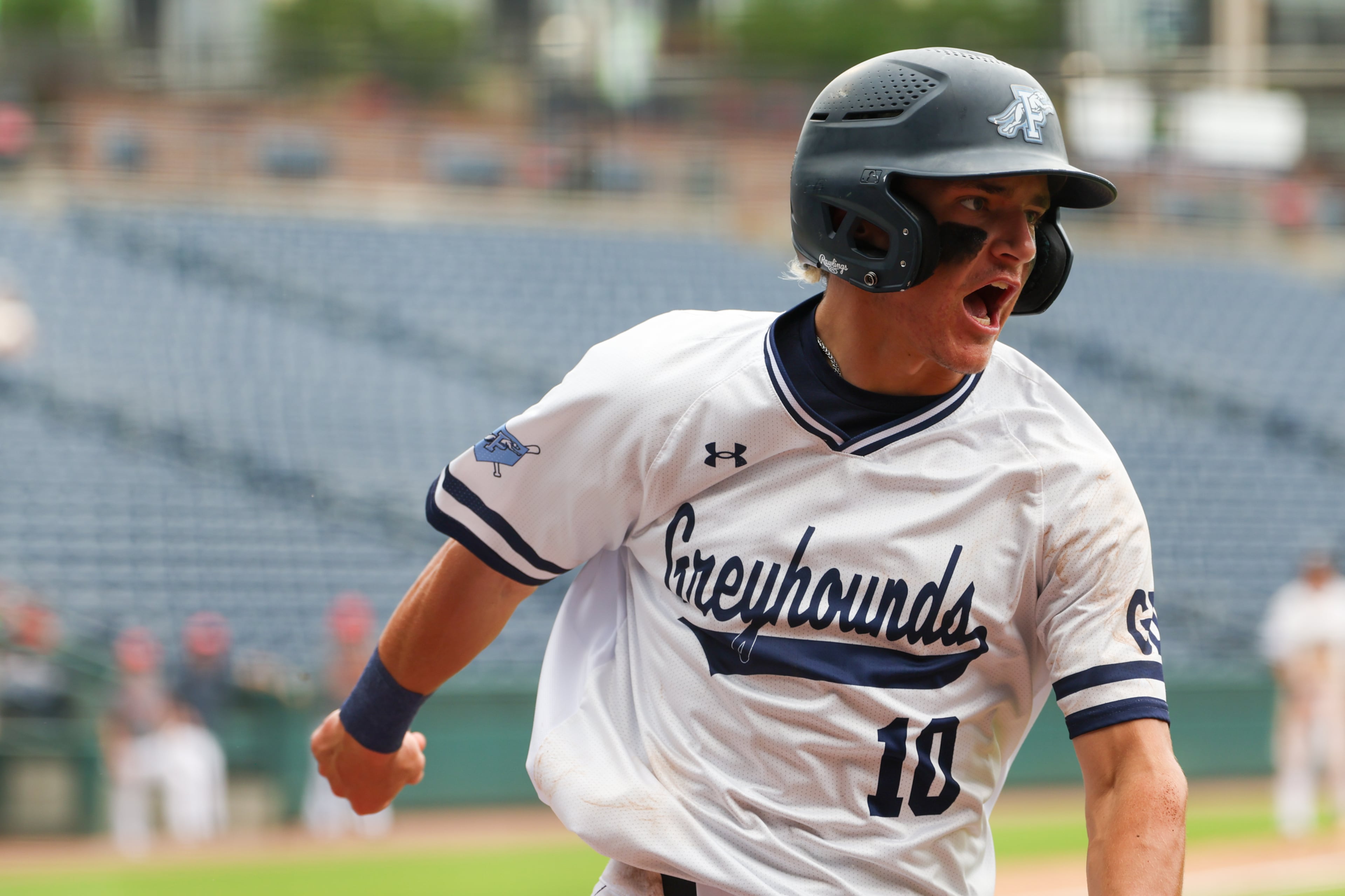 Pope’s Parker Troughton celebrates after scoring in Game 2 of their GHSA Class 5A baseball championship series against Loganville at Gwinnett Field on Tuesday, May 26, 2026, in Lawrenceville. (Arvin Temkar/AJC)