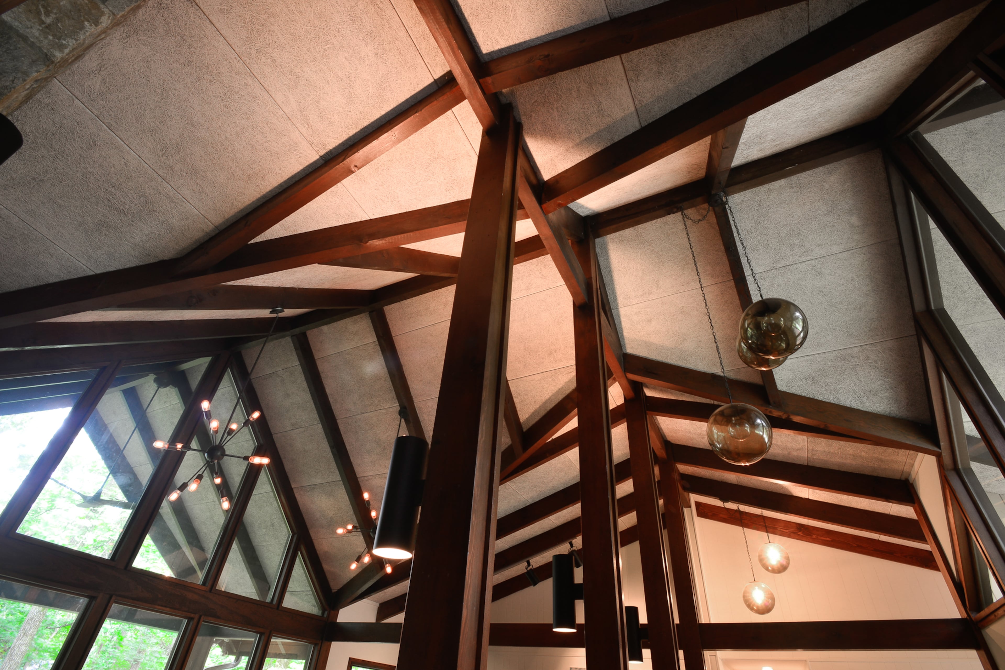 The beams define and separate the living area and dining room in the home's open floor plan.