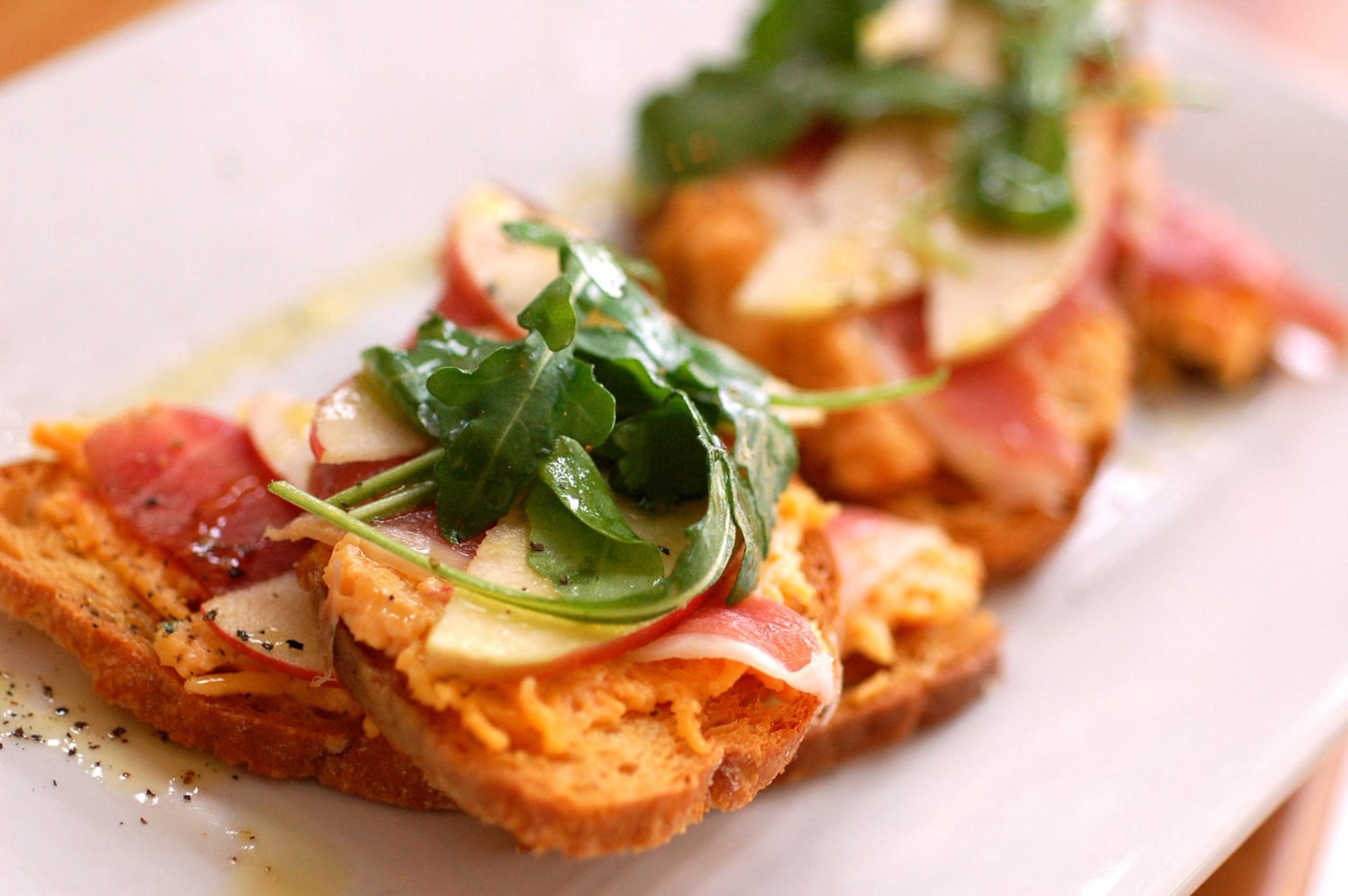 Seed Kitchen & Bar's pimento cheese crostini is topped with Benton's country ham, apples and arugula. (Courtesy of Seed Kitchen & Bar)