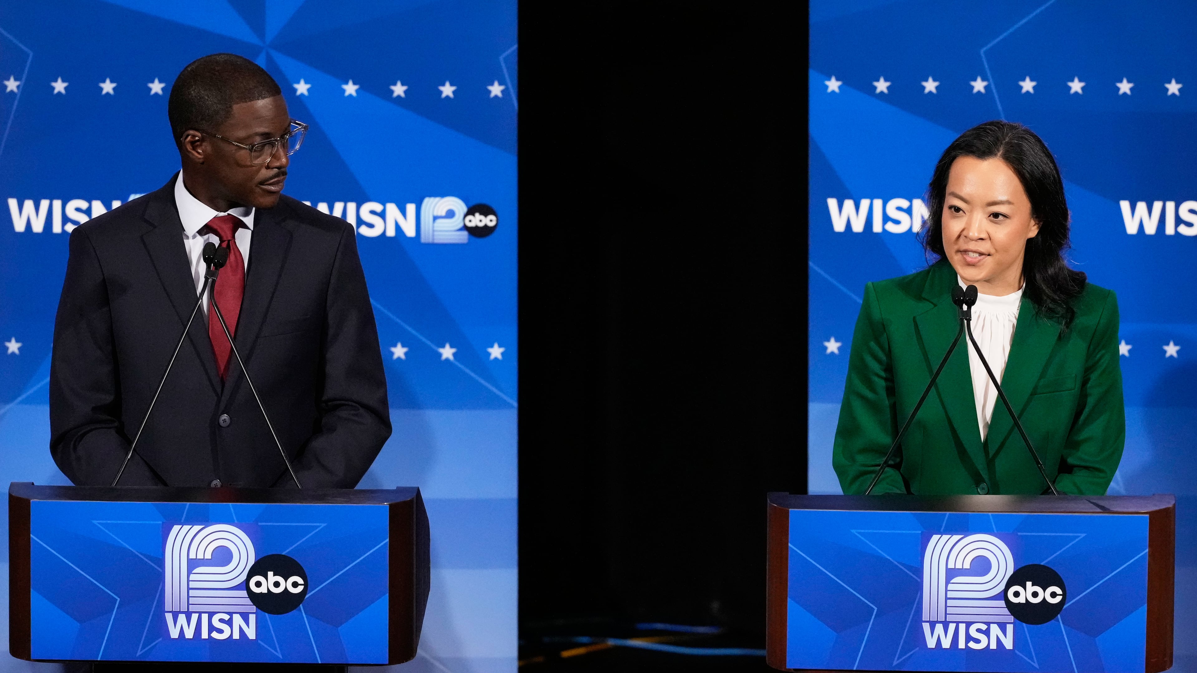 Democratic gubernatorial candidate Francesca Hong, right, talks as David Crowley listens during a primary debate in Milwaukee, Tuesday, July 28, 2026. (AP Photo/Nam Y. Huh)