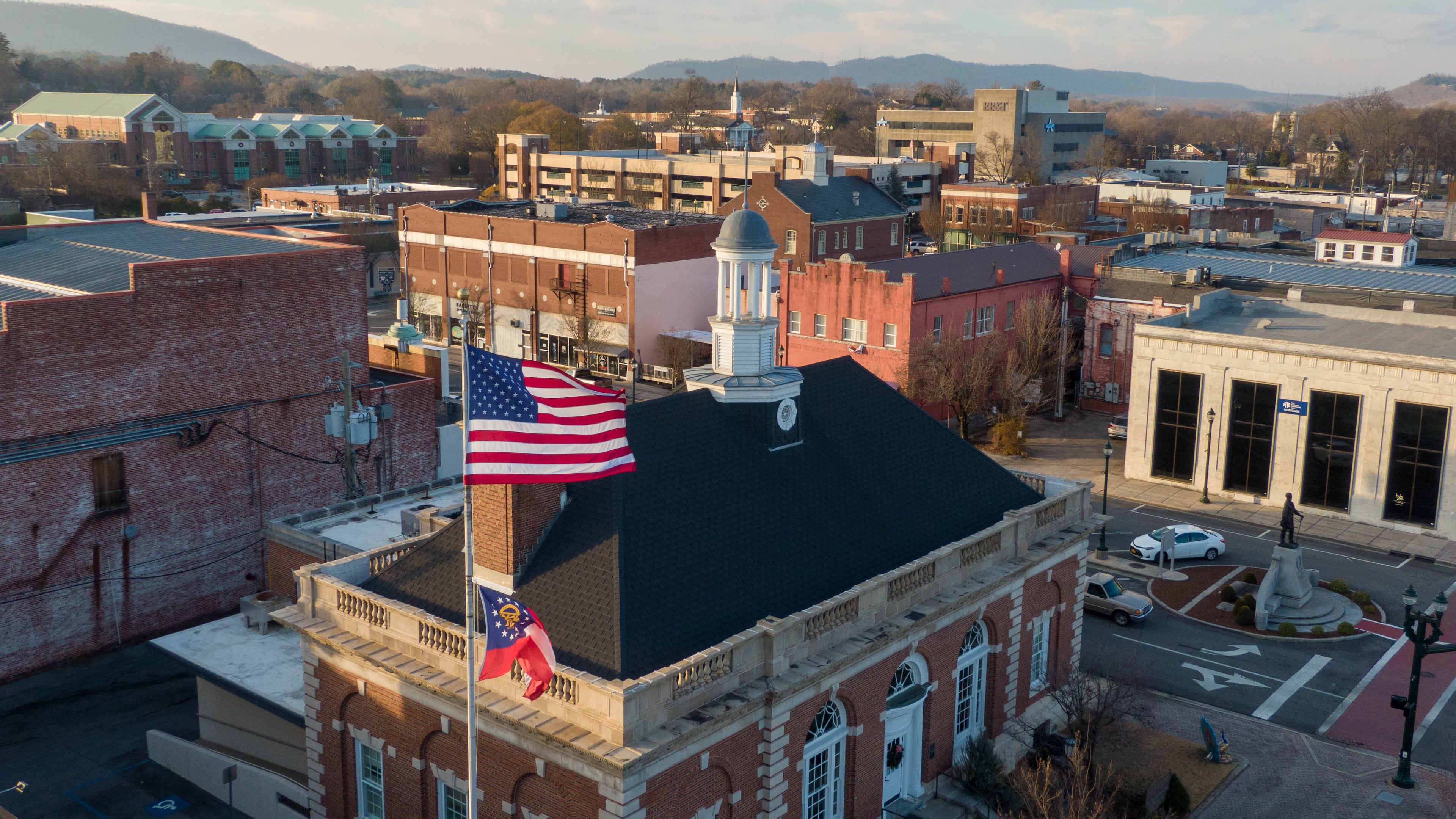 The U.S. and Georgia flags wave over downtown Dalton, in the heart of U.S. House District 14, where Clay Fuller and Shawn Harris will face each other in a runoff to replace Marjorie Taylor Greene. (Hyosub Shin/AJC 2020)