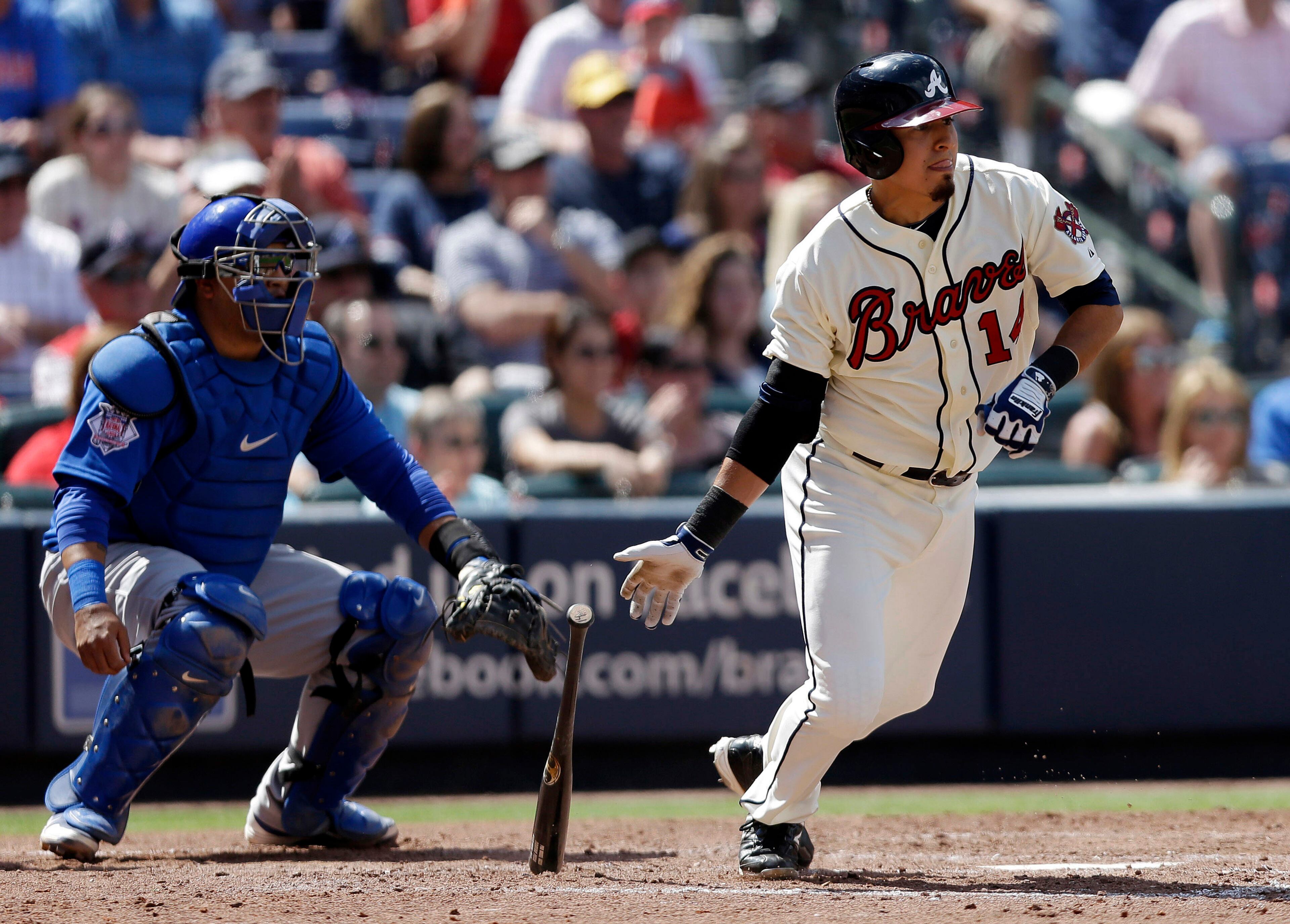 Atlanta Braves shortstop Ramiro Pena (14) follows through with a two-run base hit as Chicago Cubs catcher Dioner Navarro, left, looks on in the sixth inning.