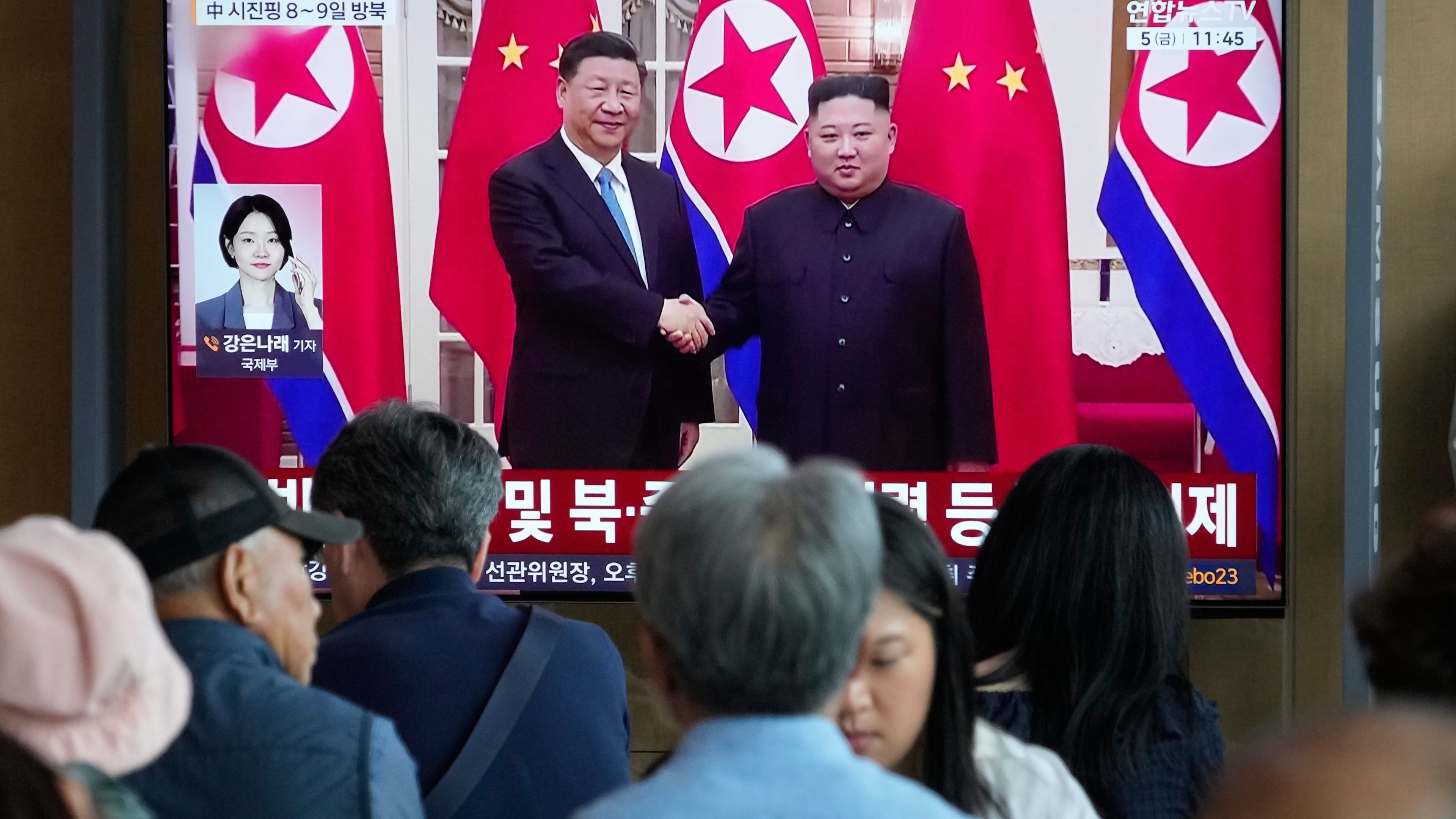 People watch a TV screen showing a file image of North Korean leader Kim Jong Un, right, and Chinese President Xi Jinping, at the Seoul Railway Station in Seoul, South Korea, Friday, June 5, 2026. (AP Photo/Ahn Young-joon)