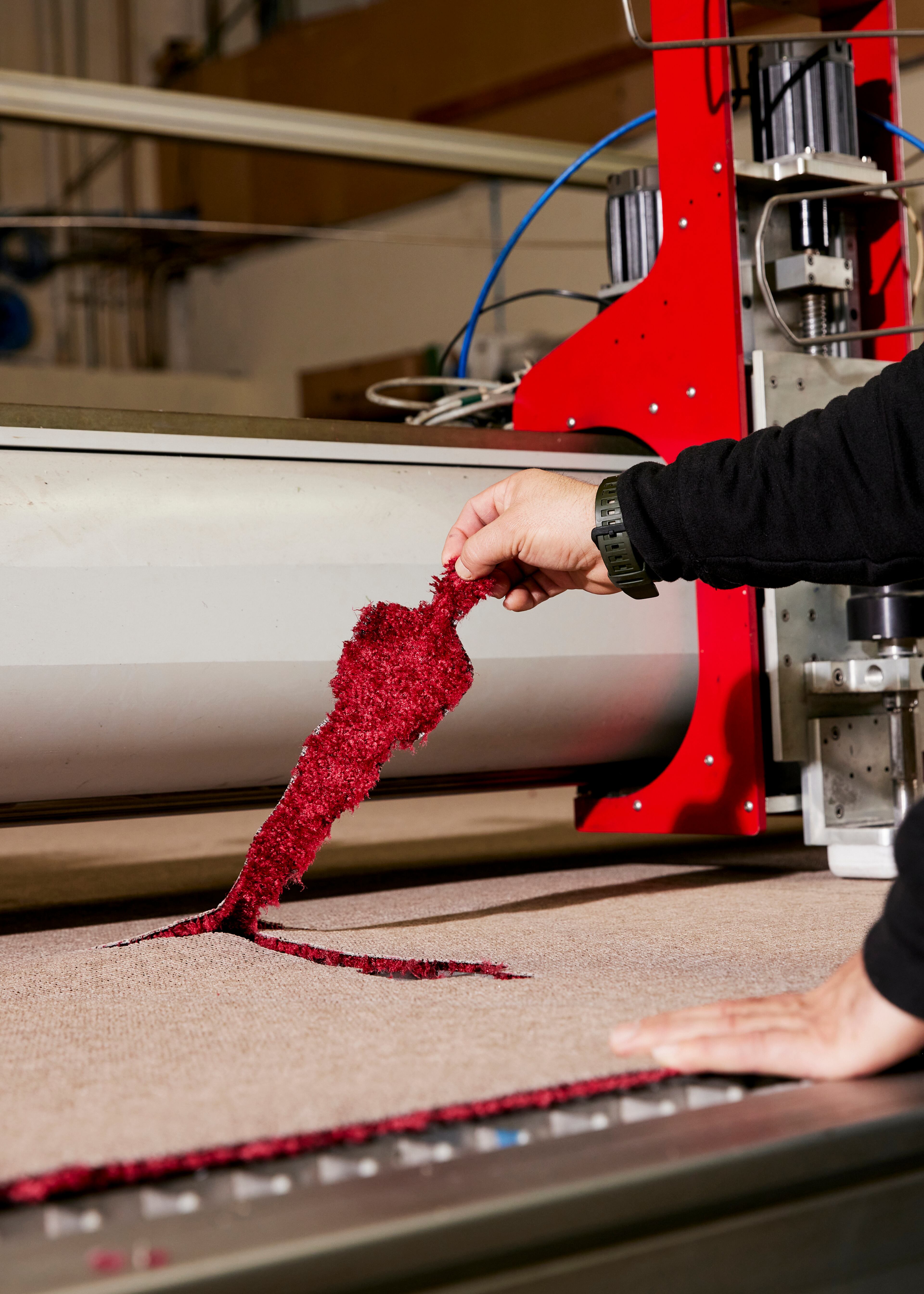 The statuette inlays are created using a high-pressure stream of water, akin to a needle, that makes the cuts according to a computer program at a warehouse in La Mirada, Calif., on Feb. 21, 2025. Steve Olive, who has worked in the event carpet business for more than three decades, is the man the Academy trusts to get its iconic rug just right. (Jennelle Fong/The New York Times)