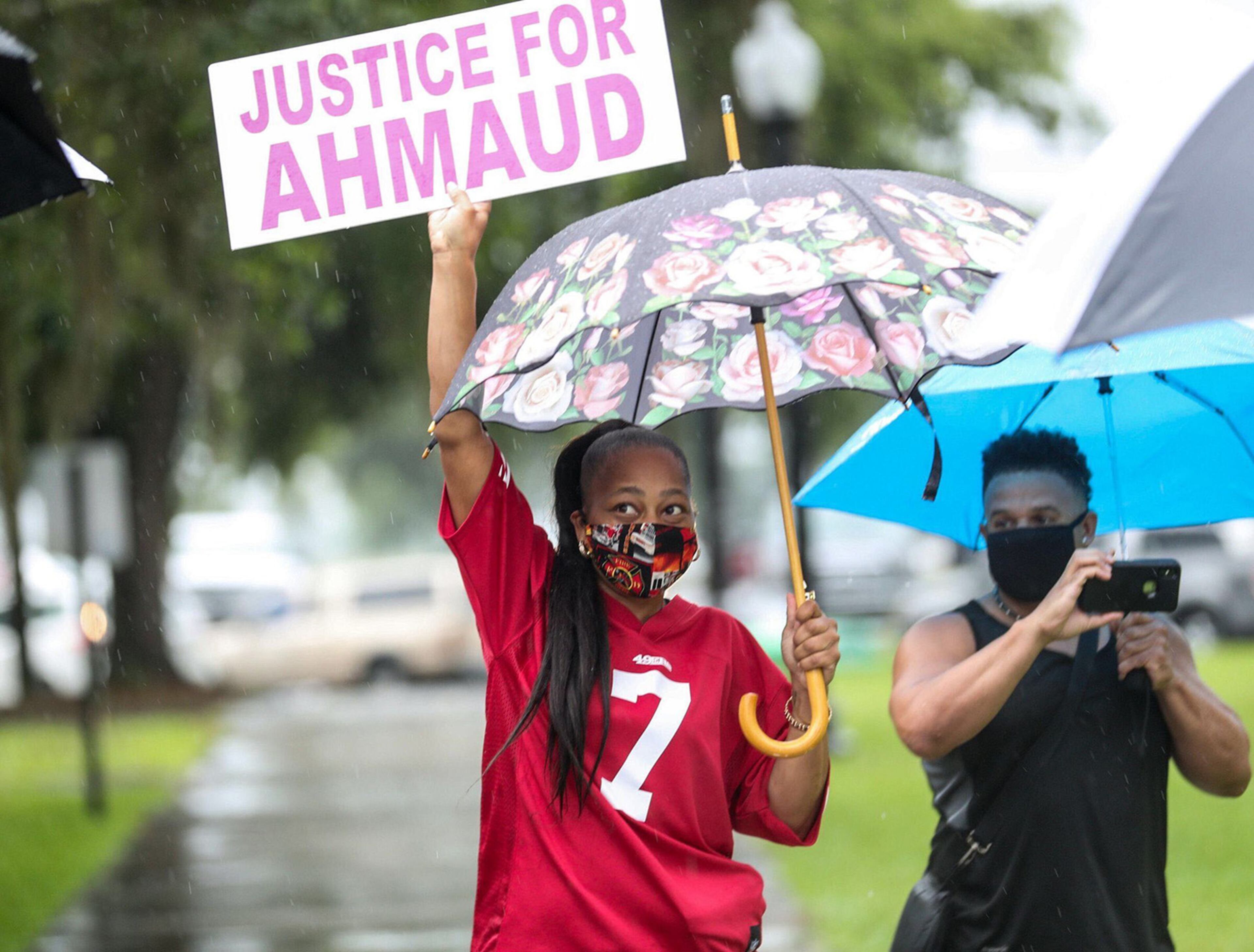 Joy Graves holds a sign outside of the Glynn County Courthouse as the preliminary preceding take place inside, Thursday, June 4, 2020. Graves says she feels anxious about the proceedings. (Alyssa Pointer / alyssa.pointer@ajc.com)