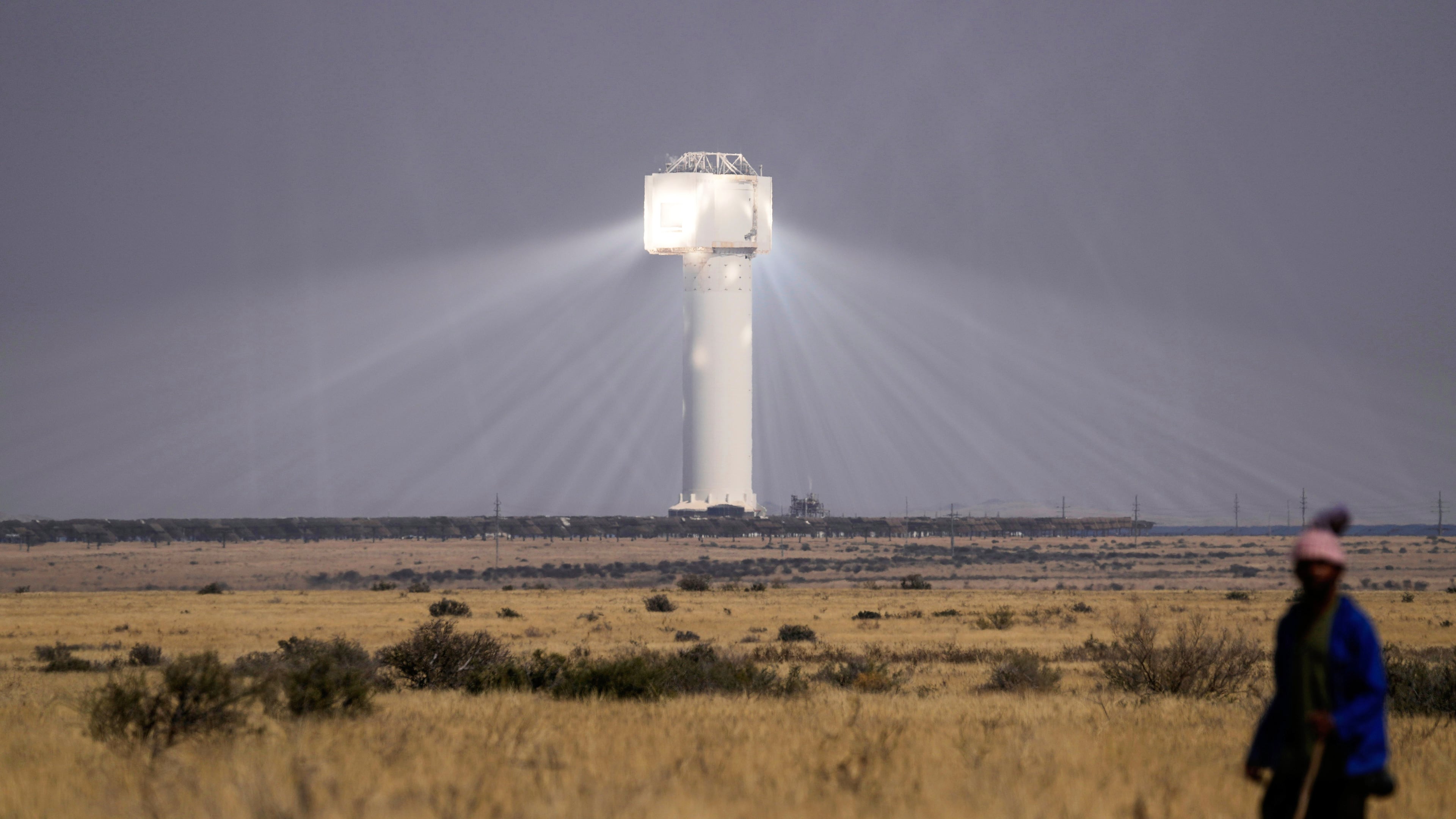 FILE - A shepherd watches livestock near Khi Solar One, a solar thermal plant that converts the sun's light energy into electricity, outside Upington, South Africa, in the Northern Cape province, Aug. 29, 2025. (AP Photo/Themba Hadebe, File)